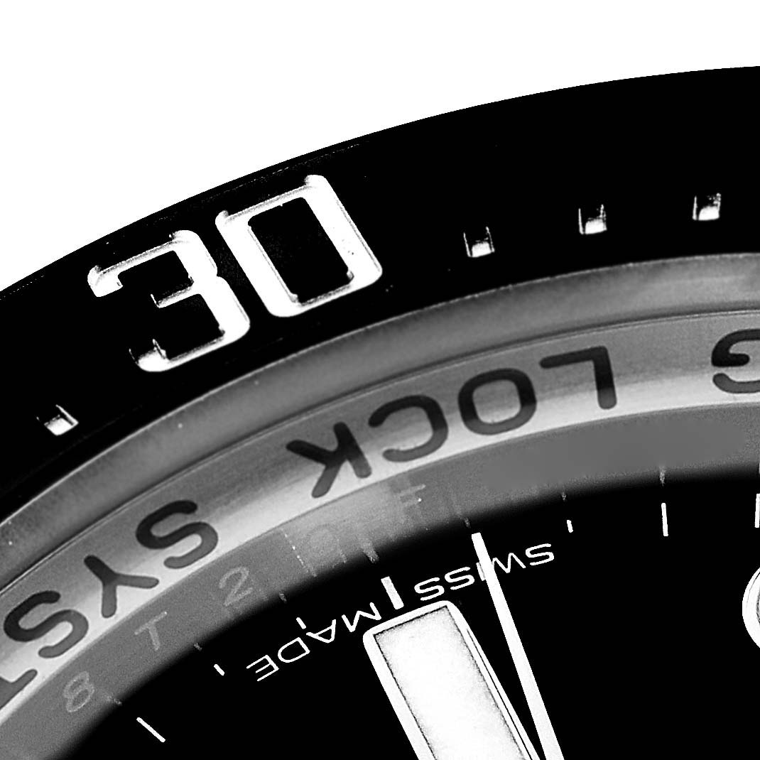 This close-up image shows the bezel and part of the dial of a Rolex Sea-Dweller 116660 Men's Stainless Steel Blue Dial 116660 Men's Stainless Steel Blue Dial watch.