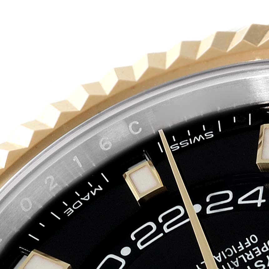 Close-up of the Rolex Sky-Dweller 326933 Men's Steel and Gold (two tone) Black Dial 326933 Men's Steel and Gold (two tone) Black Dial showing part of the bezel, dial, and hour markers at a slight angle.