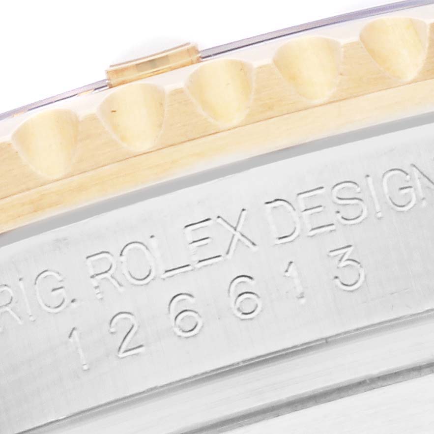 The image shows a close-up of the engraved bezel and case side of the Rolex Submariner 126613LN Men
s Steel and Gold (two tone) Black Dial 126613LN Men
s Steel and Gold (two tone) Black Dial model.