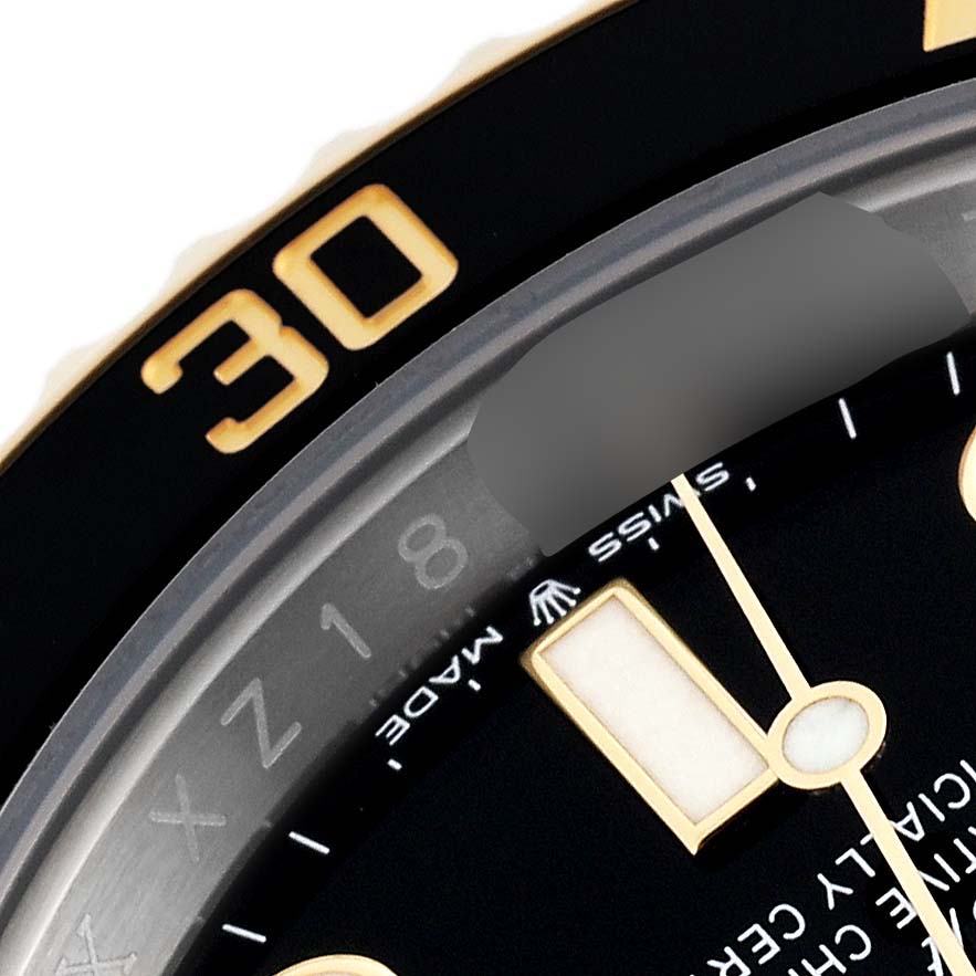 This close-up image of a Rolex Submariner 126613LN Men
s Steel and Gold (two tone) Black Dial 126613LN Men
s Steel and Gold (two tone) Black Dial watch shows part of the dial, date, and bezel, highlighting the "30" marker.