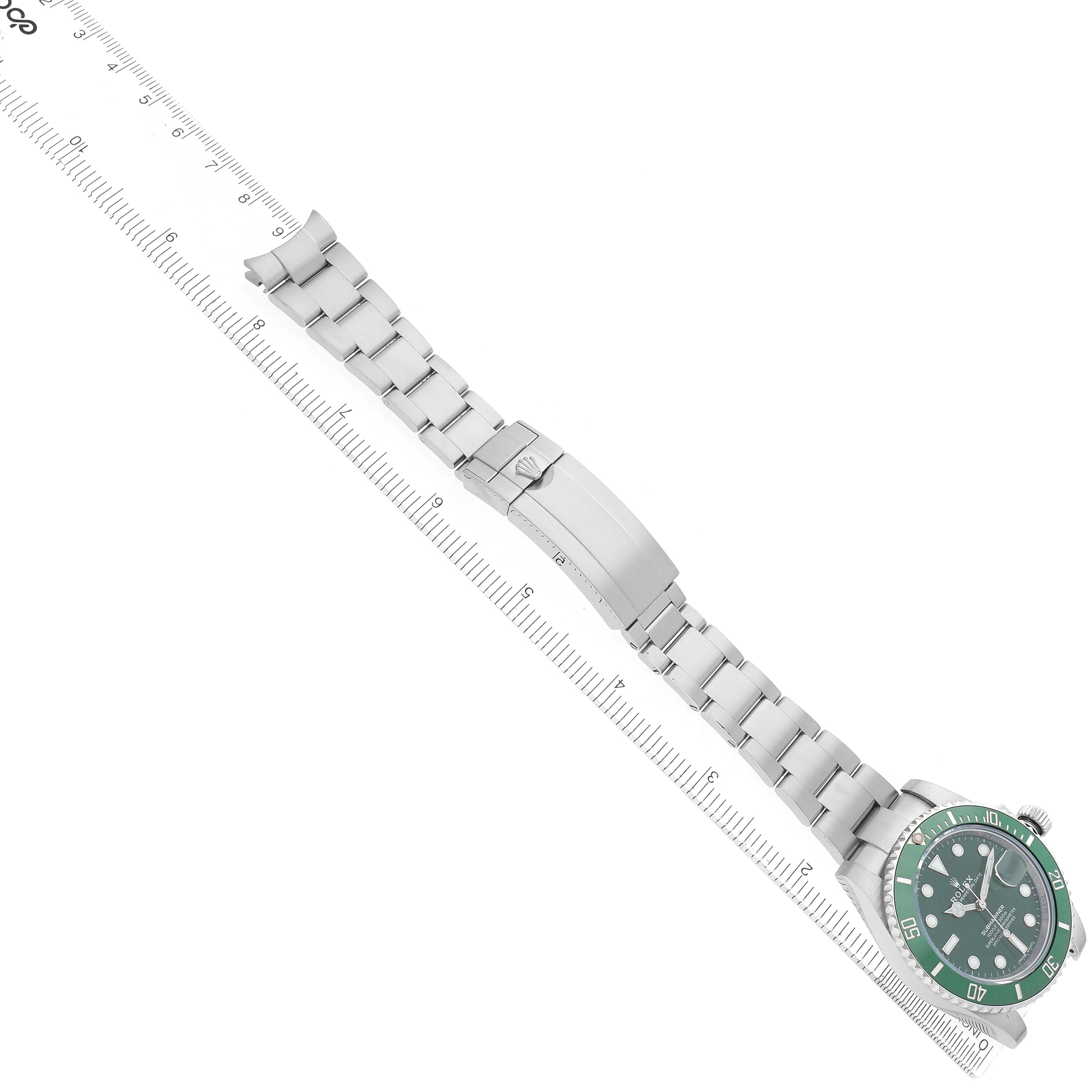 The Rolex Submariner 116610LV Men's Stainless Steel Green Dial watch is displayed diagonally, showing the bracelet, clasp, and green bezel from a top-down angle.