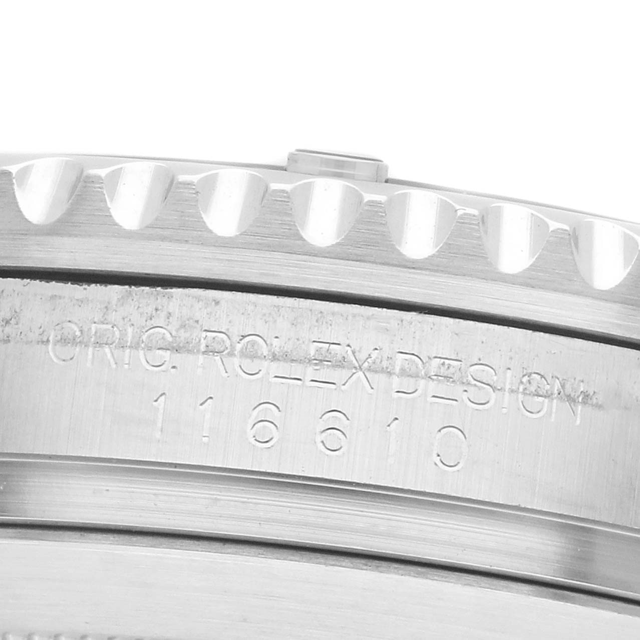 The image shows a close-up of the engraved side of the Rolex Submariner 116610LV Men's Stainless Steel Green Dial's bezel with the model number.