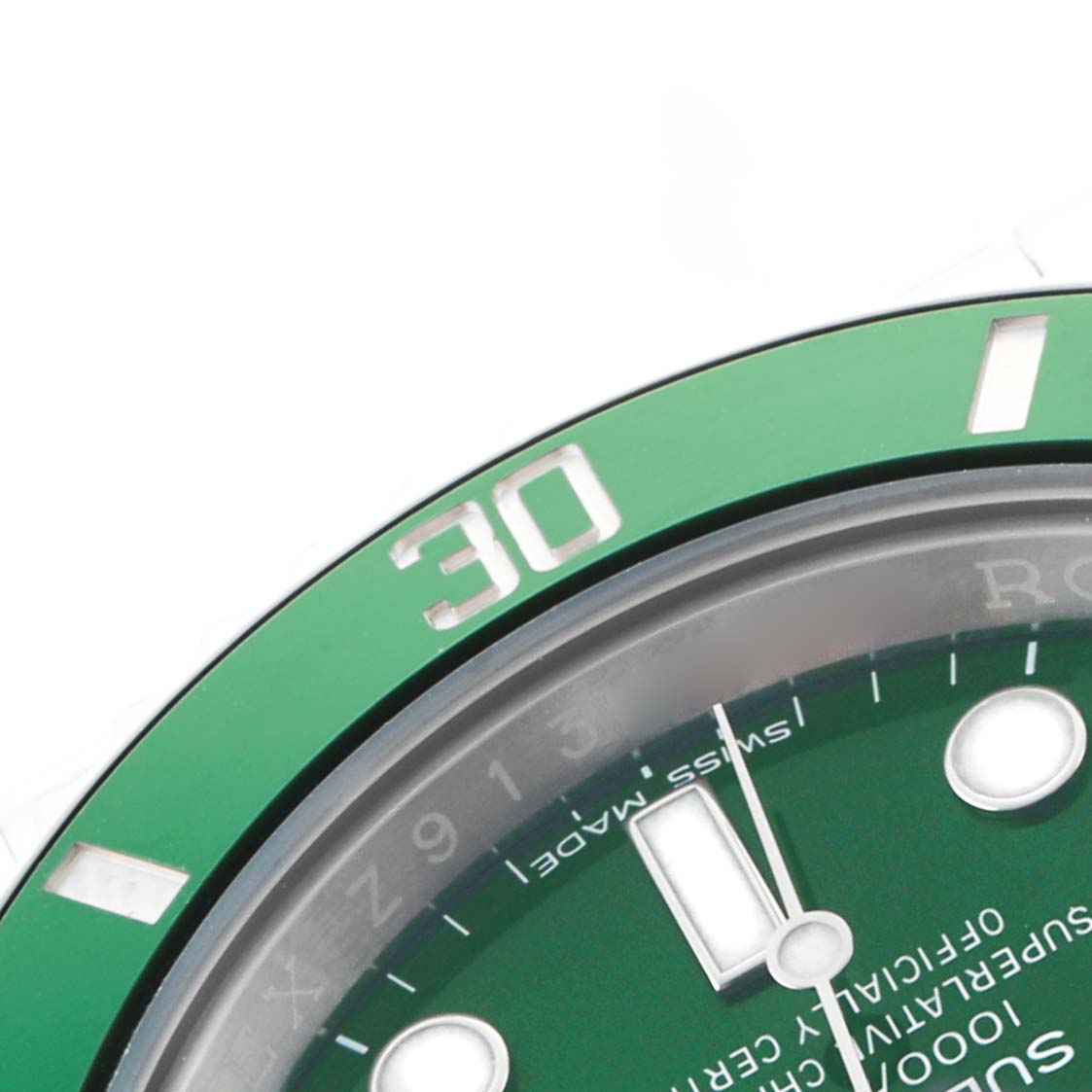The image shows the Rolex Submariner 116610LV Men's Stainless Steel Green Dial's green bezel, dial, and part of the watch face with hour markers, viewed at a close angle.