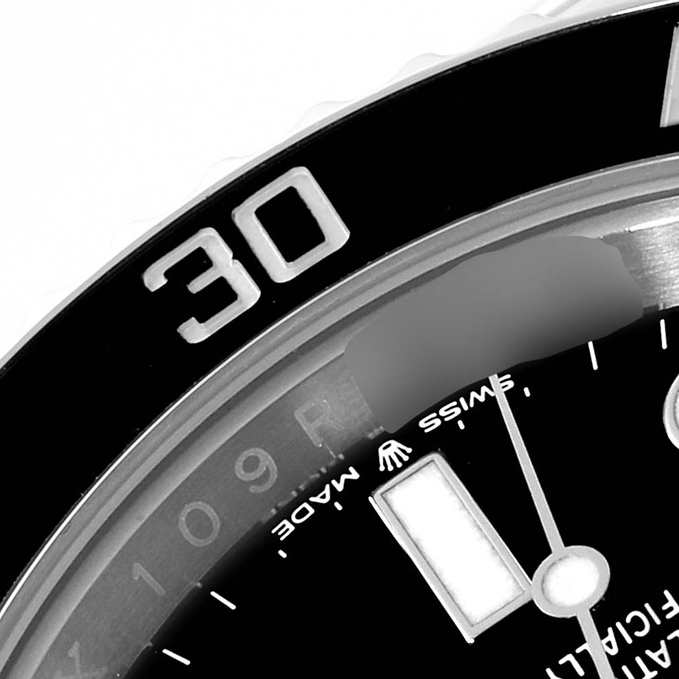The image shows a close-up of the bezel and part of the dial of the Rolex Submariner 124060 Men
s Stainless Steel Black Dial 124060 Men
s Stainless Steel Black Dial watch, specifically around the 30-minute marker.