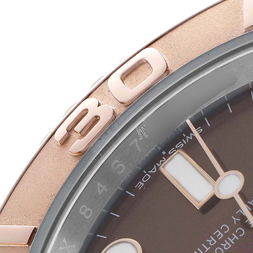 The image shows a close-up of the Rolex Yacht-Master 116621 Men's Steel and Gold (two tone) Brown Dial's bezel and part of the dial from an angled side view.