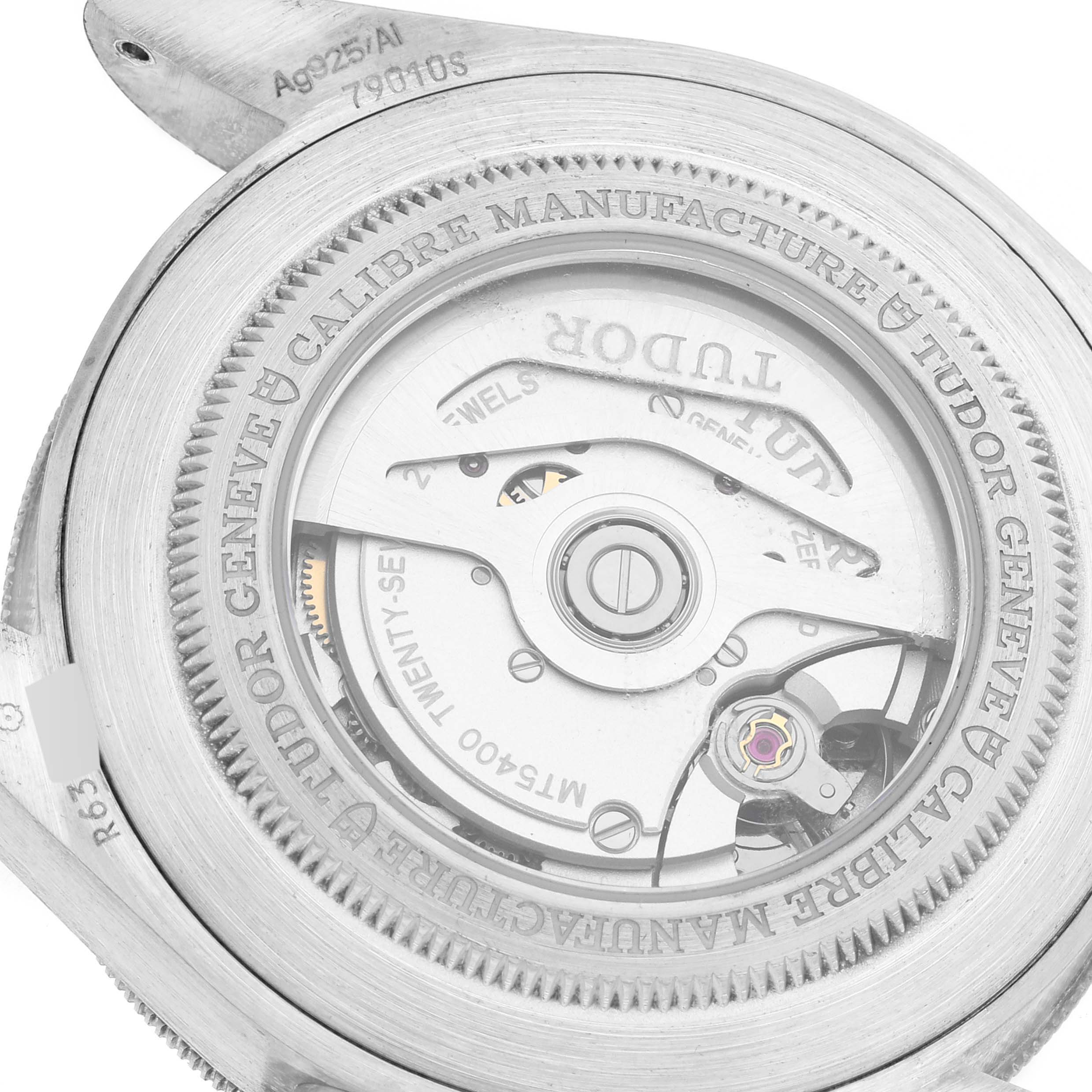 The image shows the rear view of the Tudor Heritage Black Bay 79010SG Men
s Stainless Steel Grey Dial 79010SG Men
s Stainless Steel Grey Dial watch, focusing on its mechanical movement and engravings.