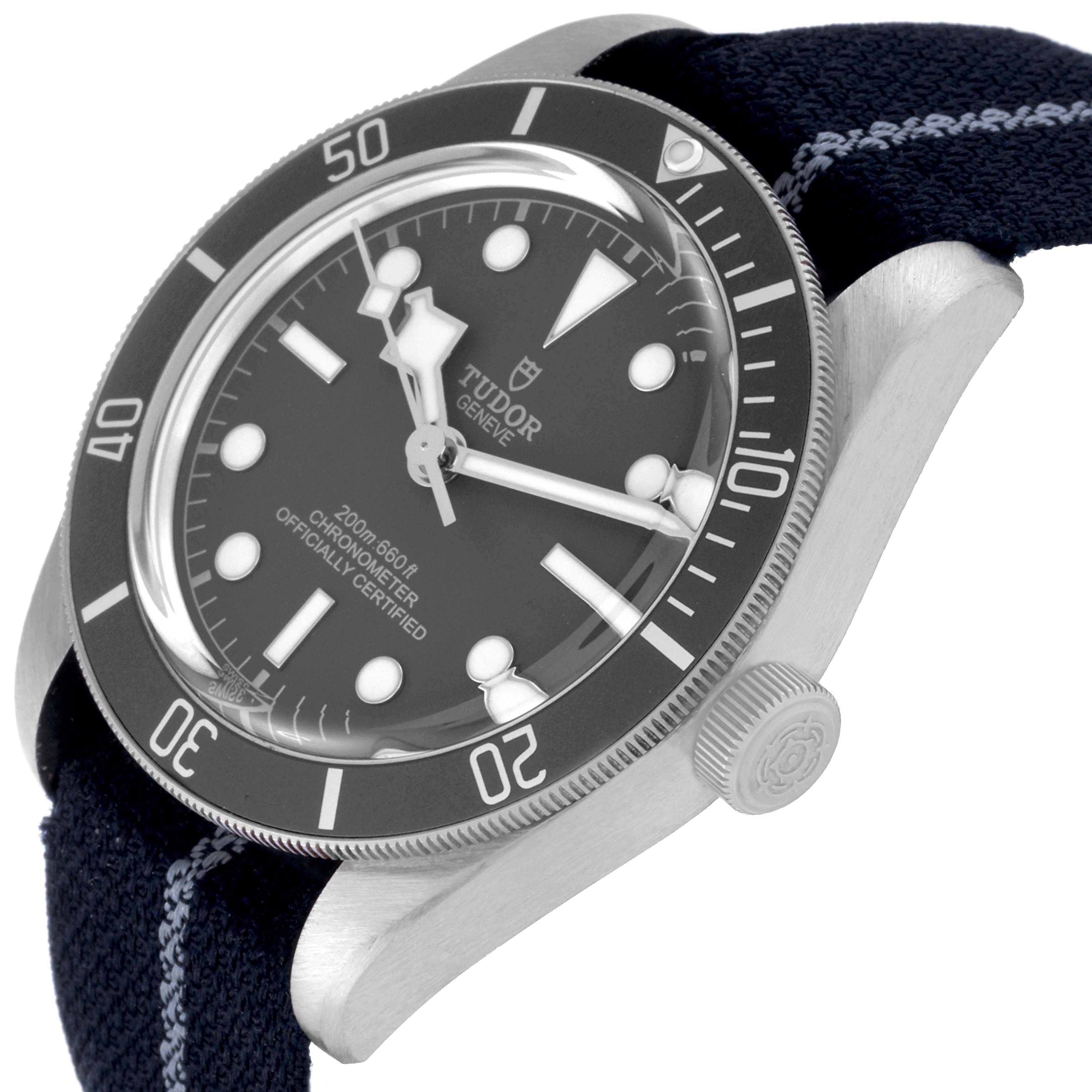 The Tudor Heritage Black Bay 79010SG Men
s Stainless Steel Grey Dial 79010SG Men
s Stainless Steel Grey Dial watch is shown from an angled side view, highlighting the bezel, dial, hands, crown, and strap.