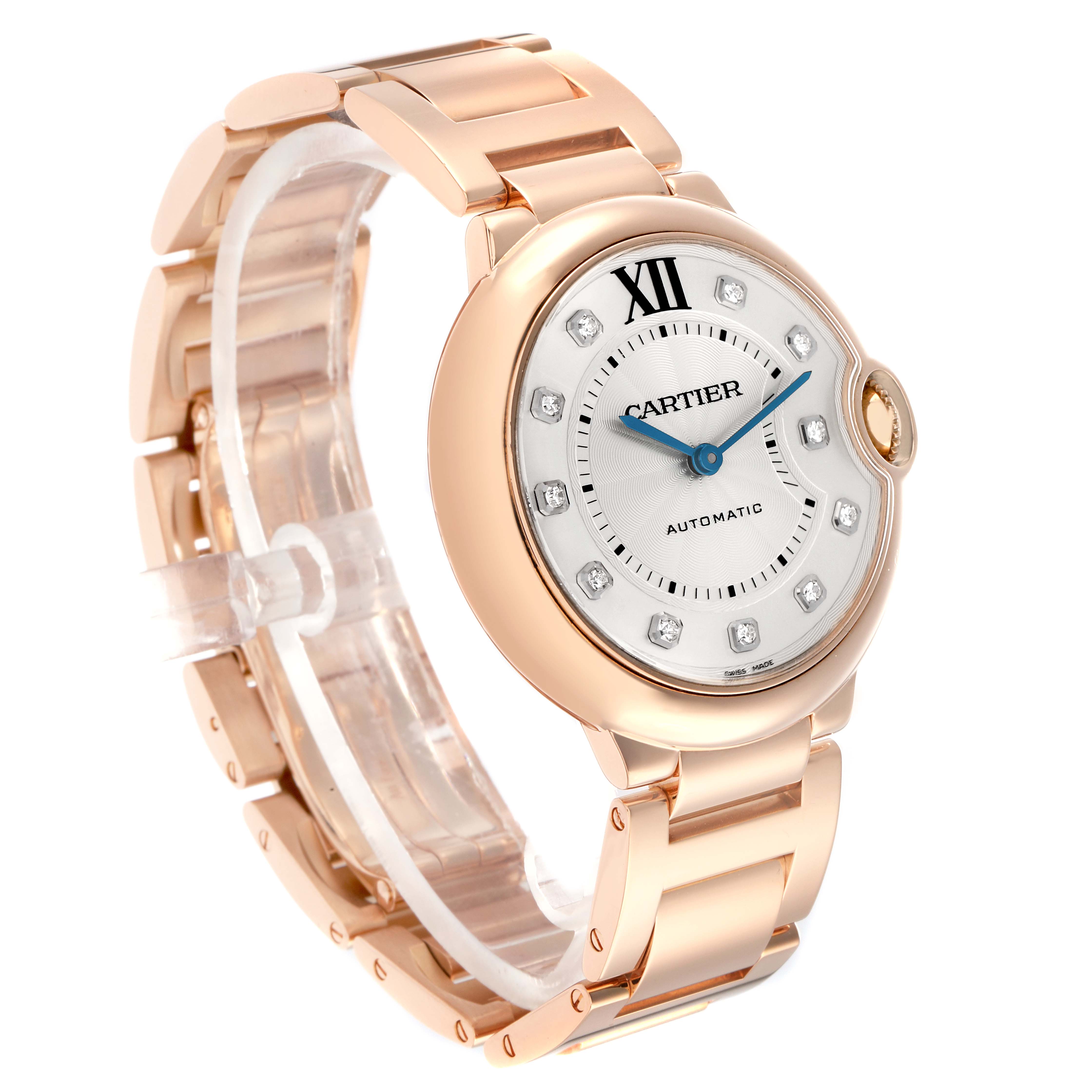 The Cartier Ballon Bleu WE902026 Women
s Rose Gold Silver Dial watch is shown at a three-quarter angle, displaying its rose gold case, bracelet, and diamond hour markers.