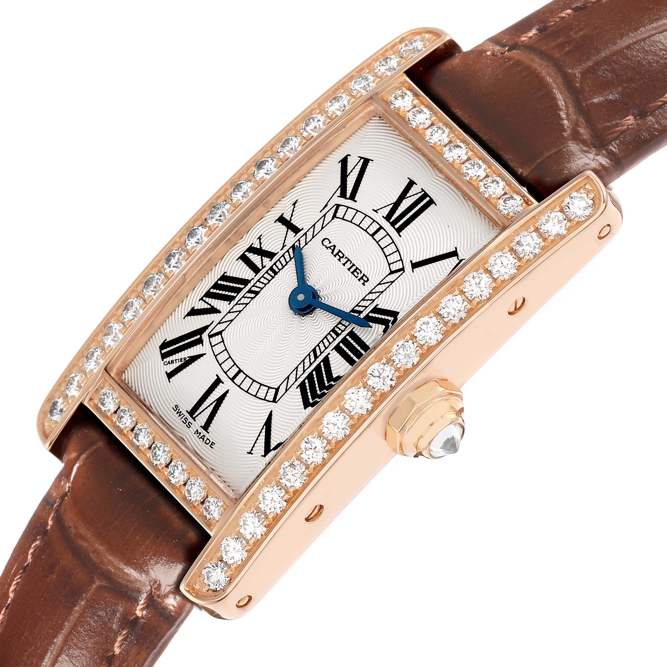 The Cartier Tank Americaine WJTA0002 Women
s Rose Gold Silver Dial watch is shown from an angled top view, highlighting its diamond-encrusted case and leather strap.