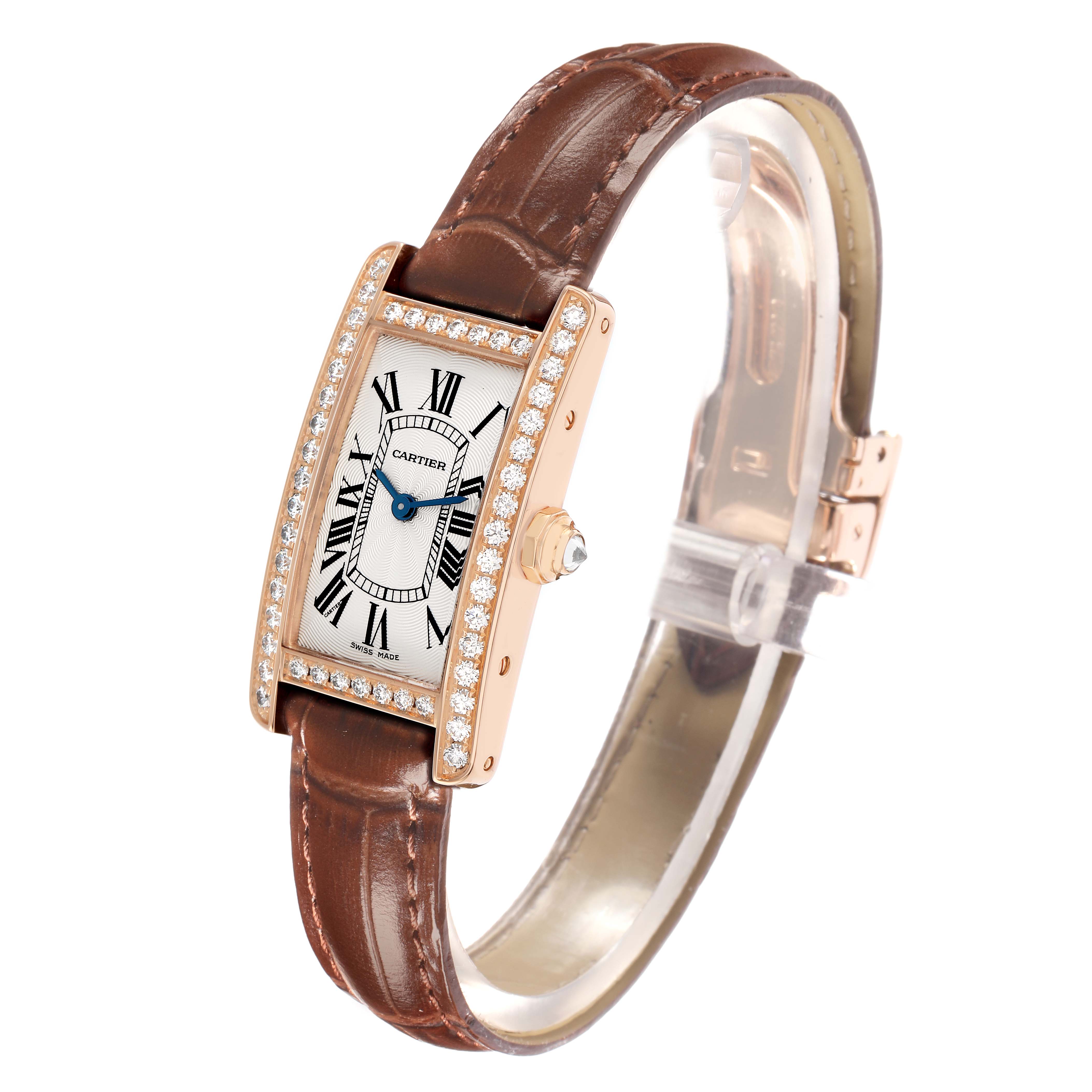 The Cartier Tank Americaine WJTA0002 Women
s Rose Gold Silver Dial watch is shown at a slight angle, displaying the face, diamond bezel, brown strap, and crown.