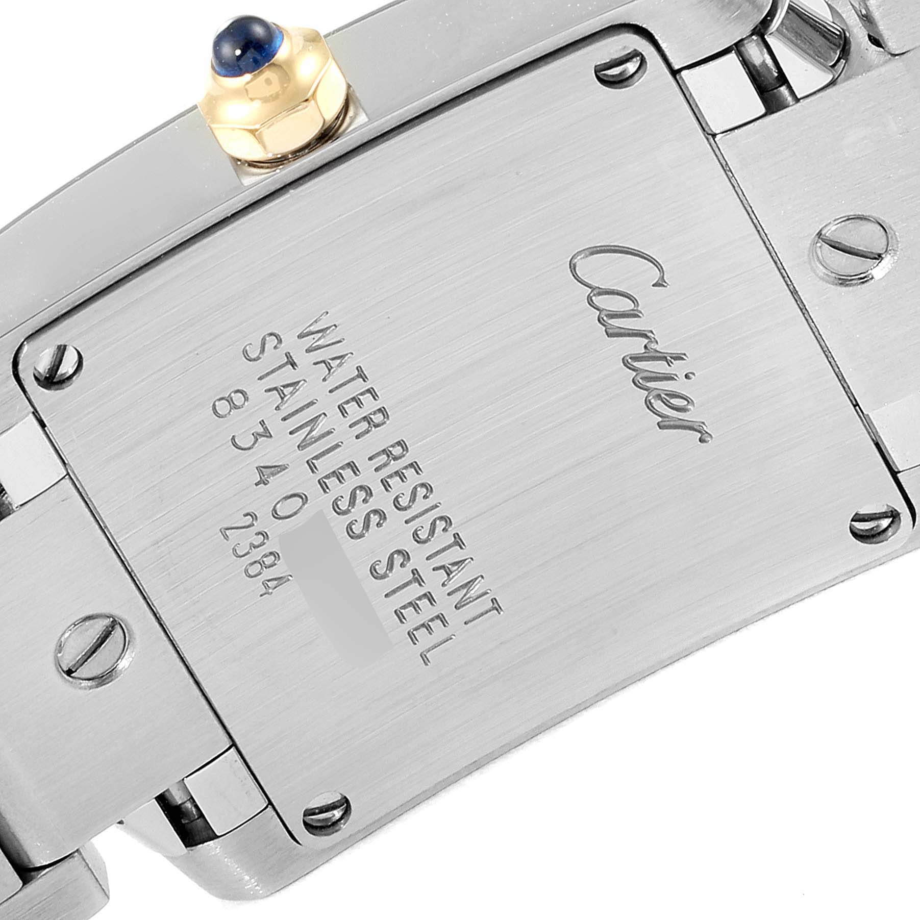 The image shows the back case and part of the strap of the Cartier Tank Française watch, displaying its inscriptions and details.