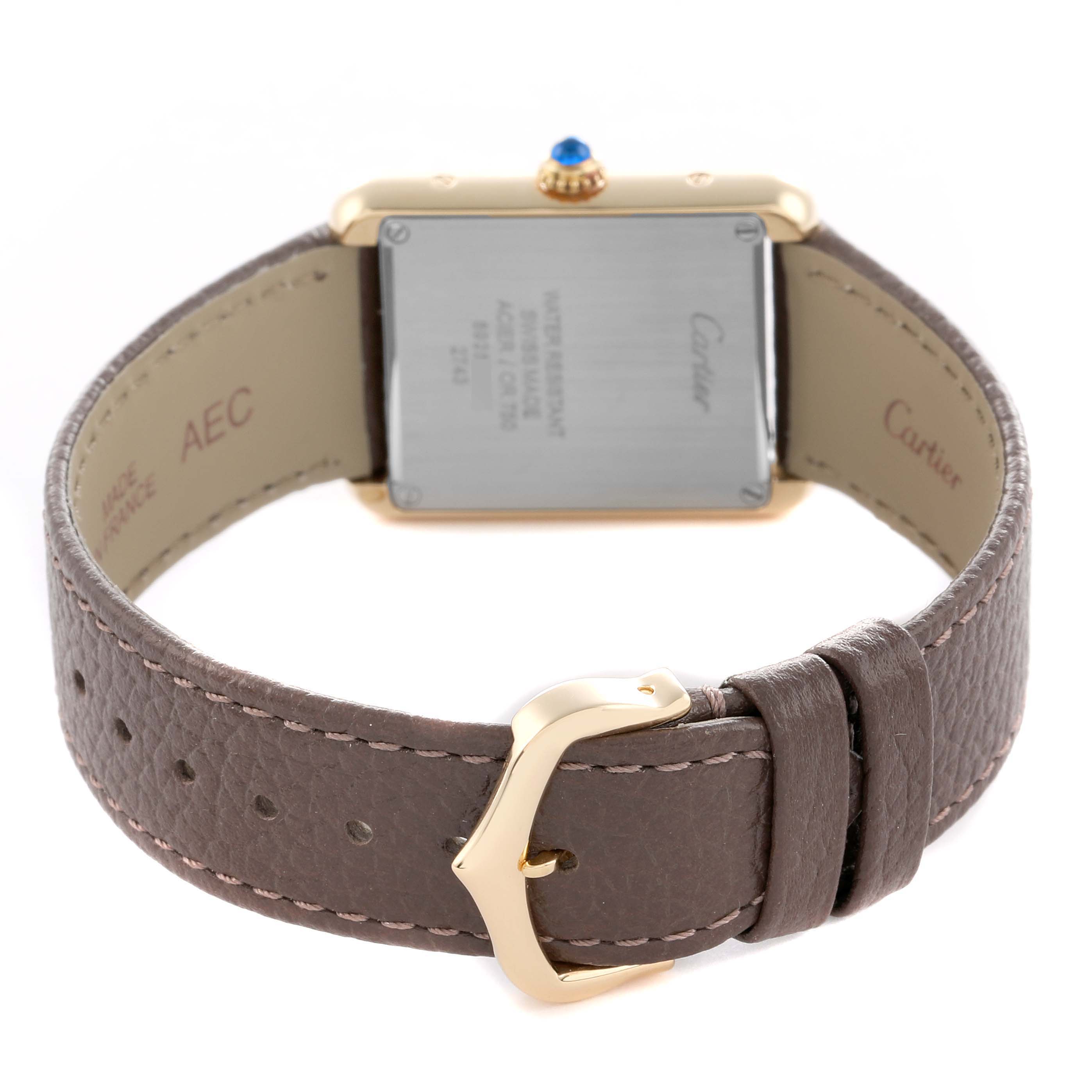 The Cartier Tank Solo W1018755 Women
s Steel and Gold (two tone) Silver Dial watch is shown from the back, highlighting its leather strap and buckle.