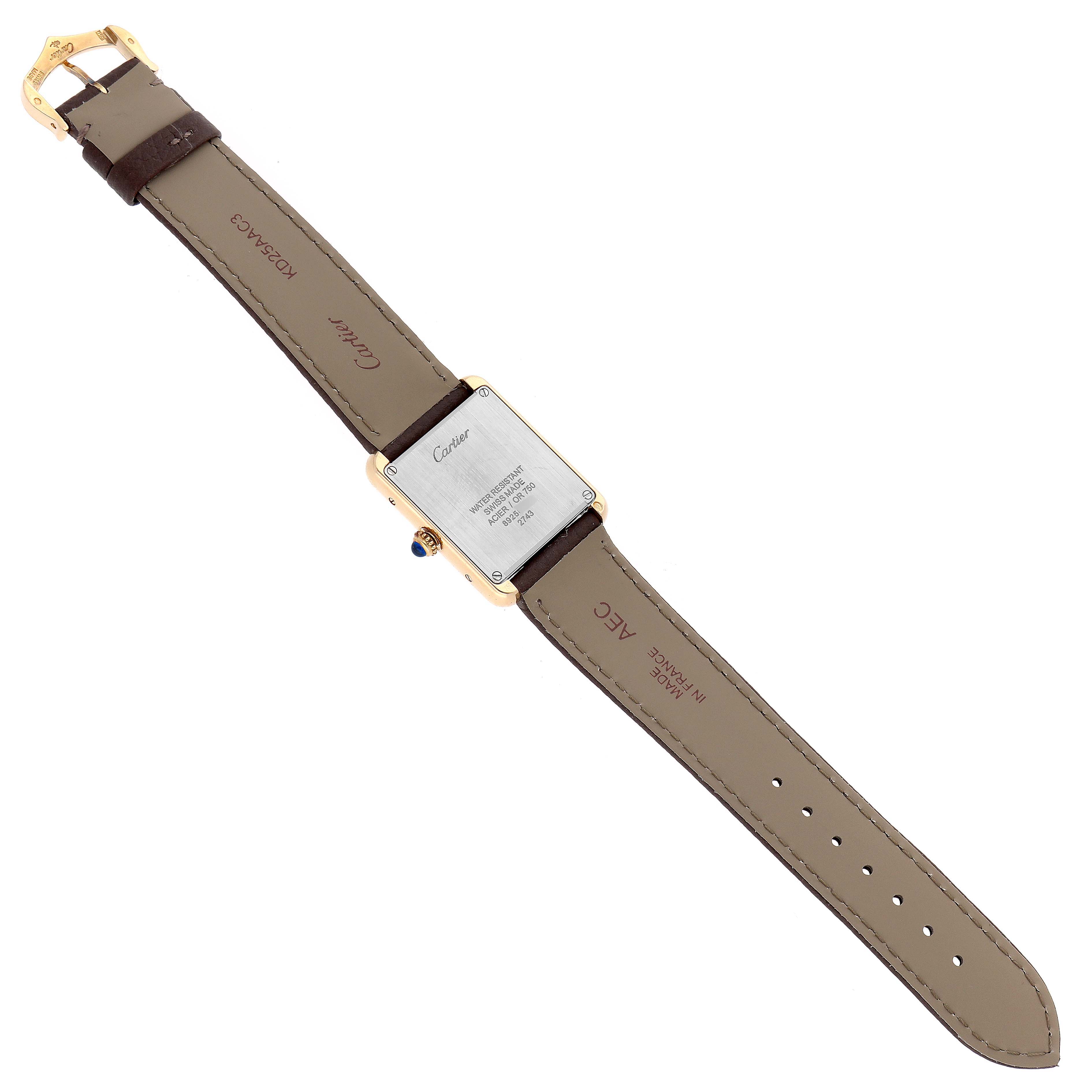 The image shows the back of a Cartier Tank Solo W1018755 Women
s Steel and Gold (two tone) Silver Dial watch, displaying the case back, buckle, and leather strap.