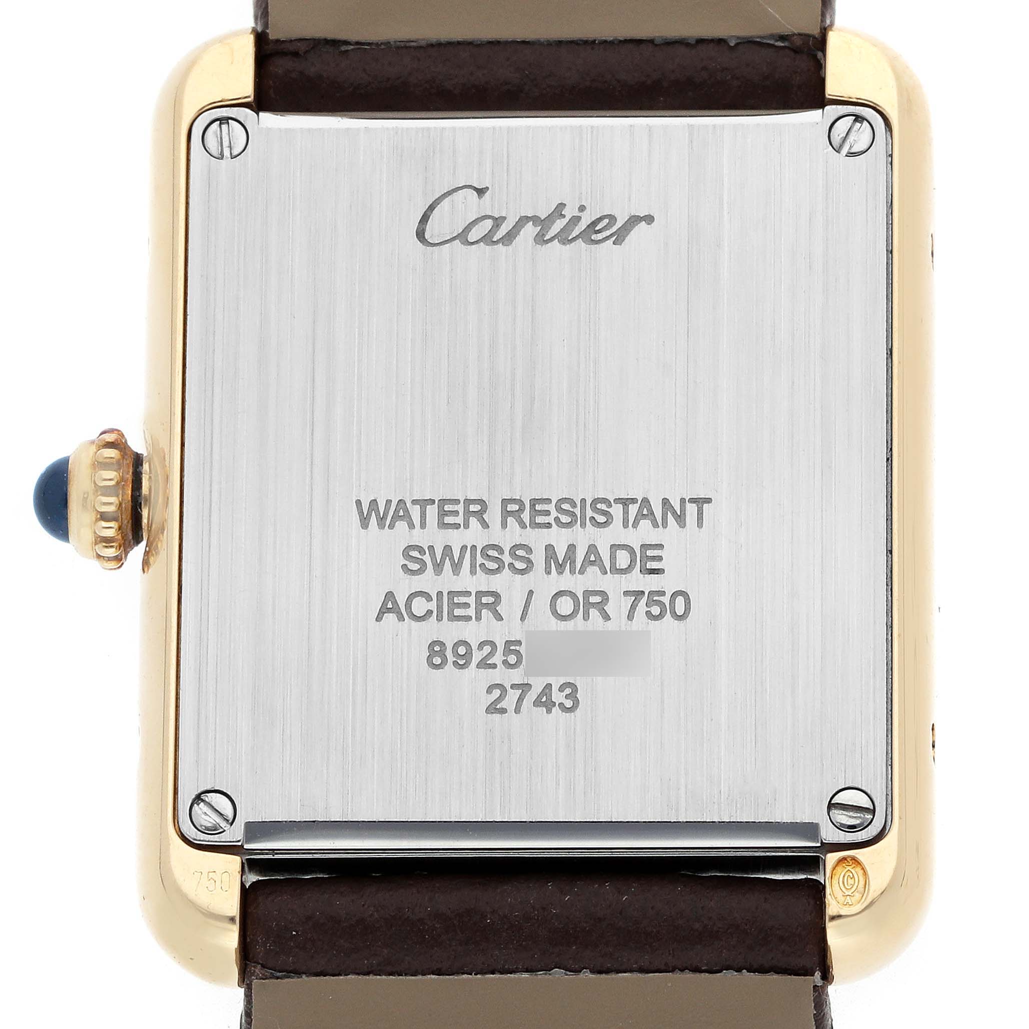 The image shows the back of a Cartier Tank Solo W1018755 Women
s Steel and Gold (two tone) Silver Dial watch, featuring its case, screws, and crown with a blue cabochon.