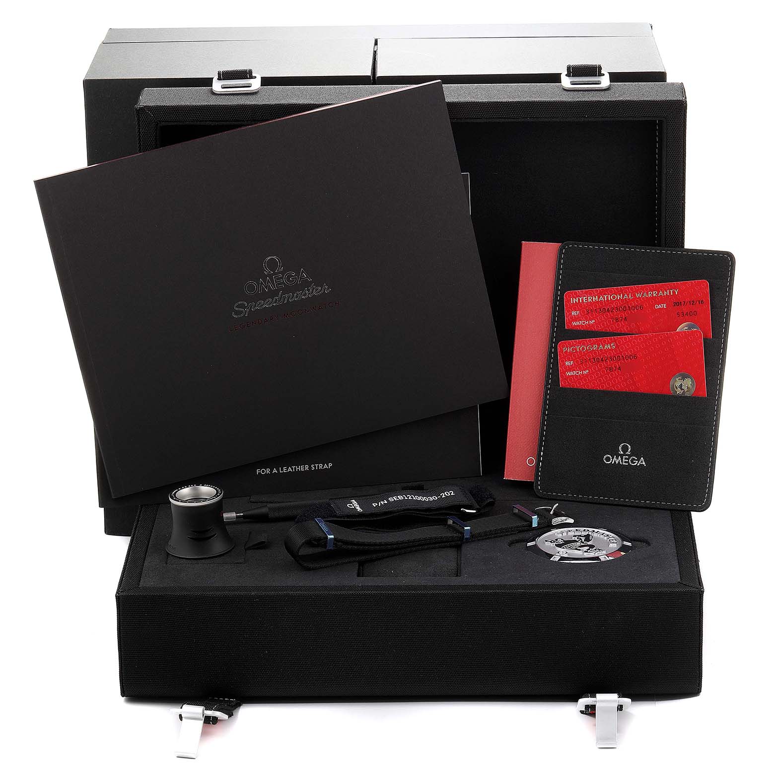 The Omega Speedmaster 311.30.42.30.01.006 Men's Stainless Steel Black Dial 311.30.42.30.01.006 Men's Stainless Steel Black Dial watch packaging showcases various accessories including booklets, warranty cards, tools, and straps.