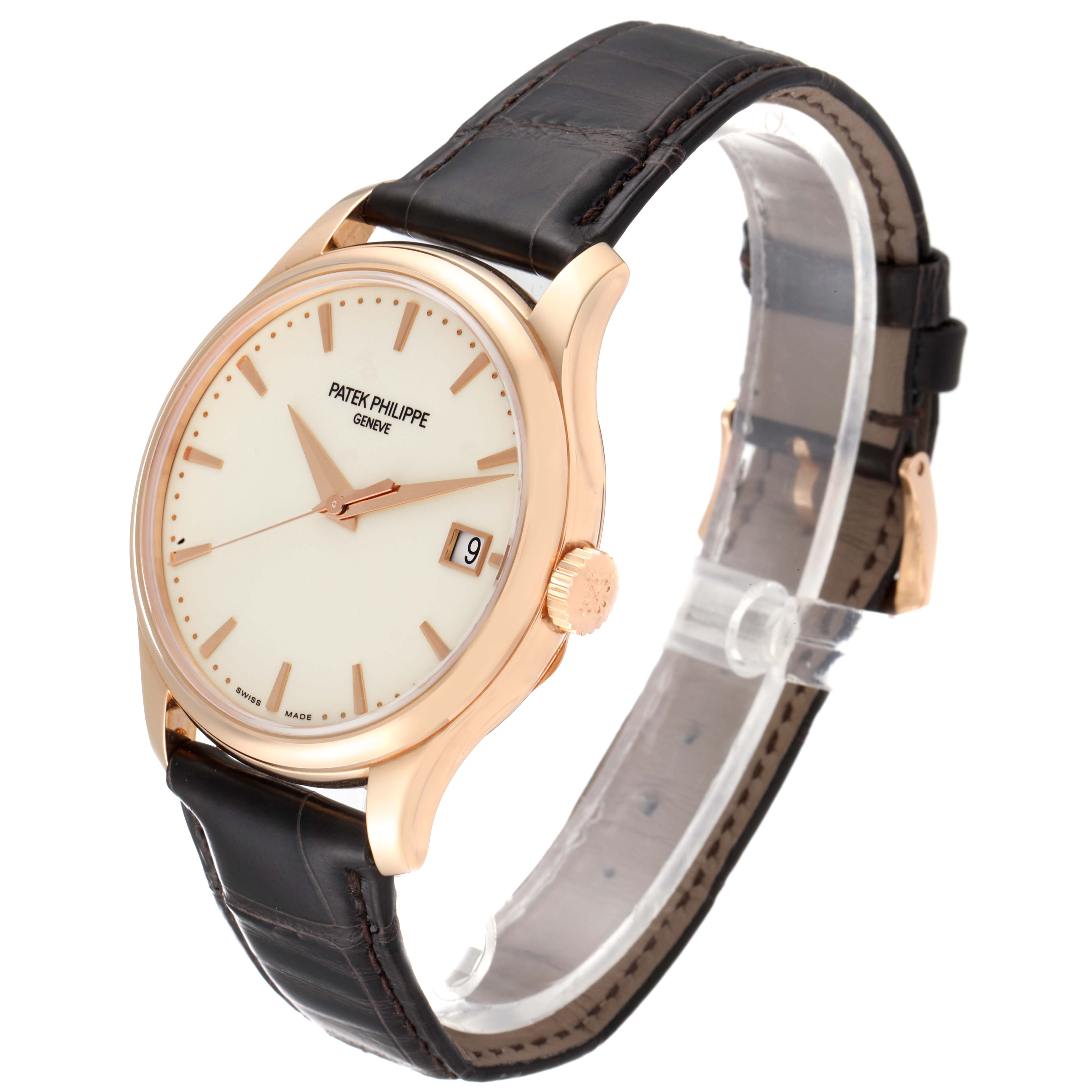 The image shows a Patek Philippe Calatrava 5227R-001 Men's Rose Gold Beige Dial 5227R-001 Men's Rose Gold Beige Dial watch from a three-quarter angle, displaying its face, case, crown, and leather strap.