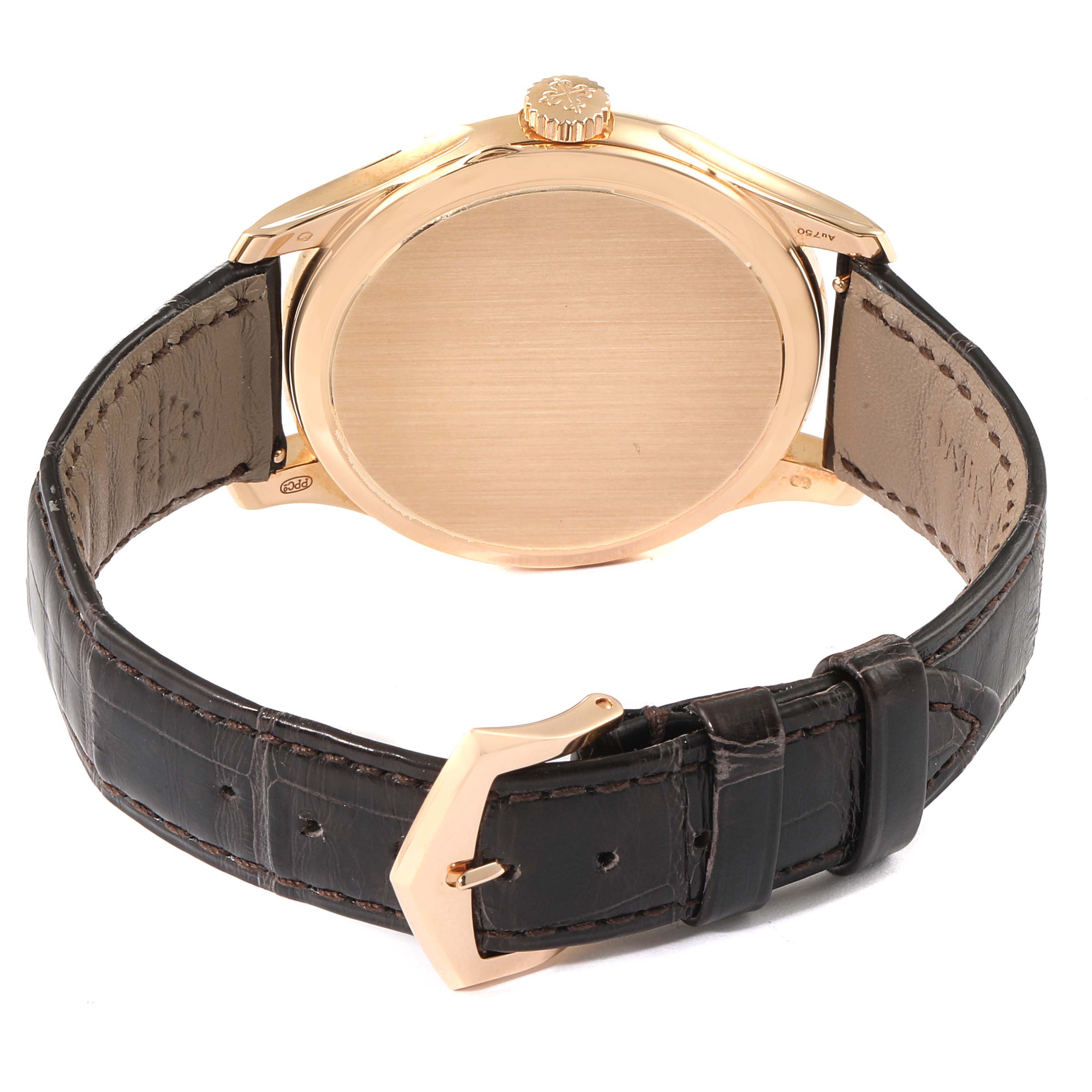 The image shows the back and side view of the Calatrava model watch by Patek Philippe, highlighting the case back, crown, and leather strap.