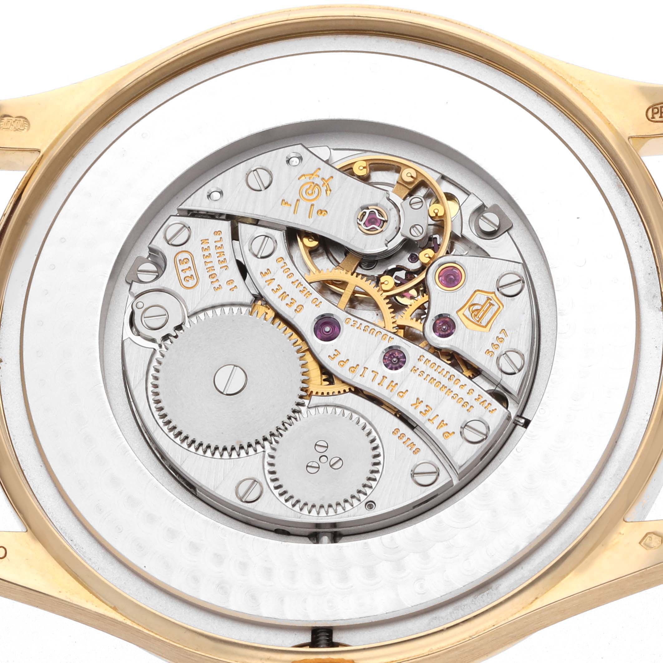 The image shows the movement of a Patek Philippe Calatrava Yellow Gold 5196J, highlighting its intricate gears and components from the back.