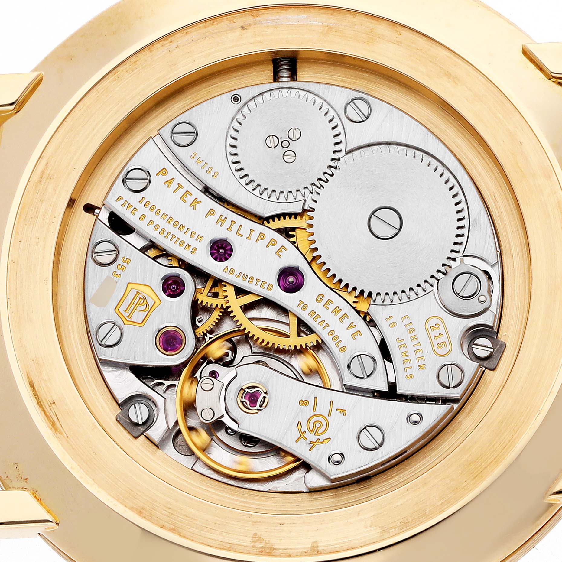 The image shows the movement of a Patek Philippe Calatrava 5119J-001 Men
s Yellow Gold White Dial watch viewed from the back, featuring its intricate gears and components.