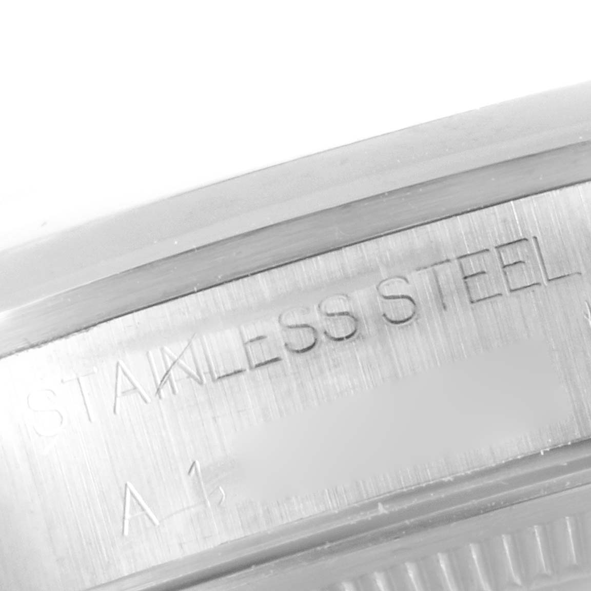 This close-up image shows the engraving on the stainless steel case back of a Rolex Air-King 14000 Men's Stainless Steel Black Dial 14000 Men's Stainless Steel Black Dial watch.