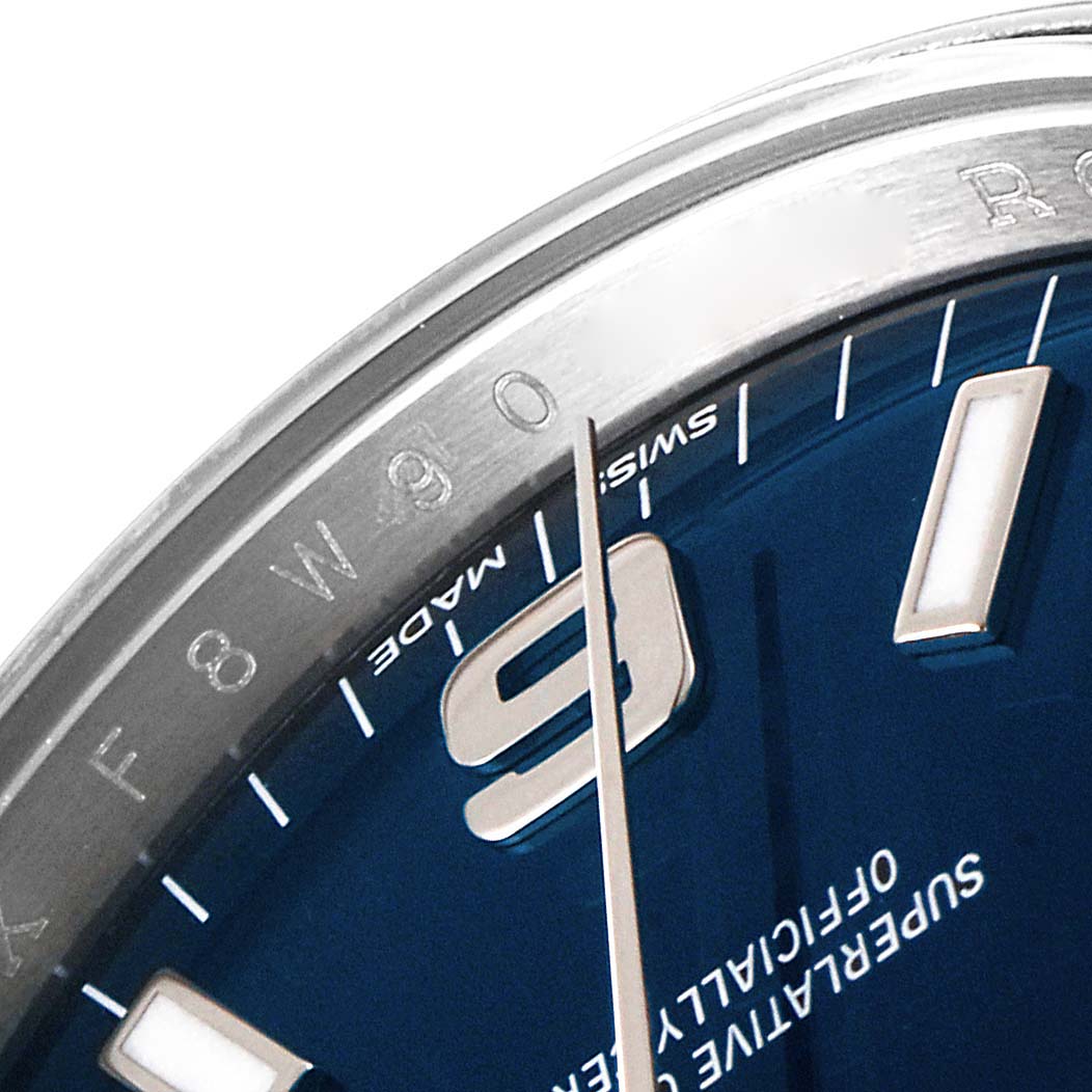 The image shows a close-up of the dial and bezel of a Rolex Air-King 114200 Men's Stainless Steel Blue Dial 114200 Men's Stainless Steel Blue Dial watch, including the hour markers and part of the second hand.