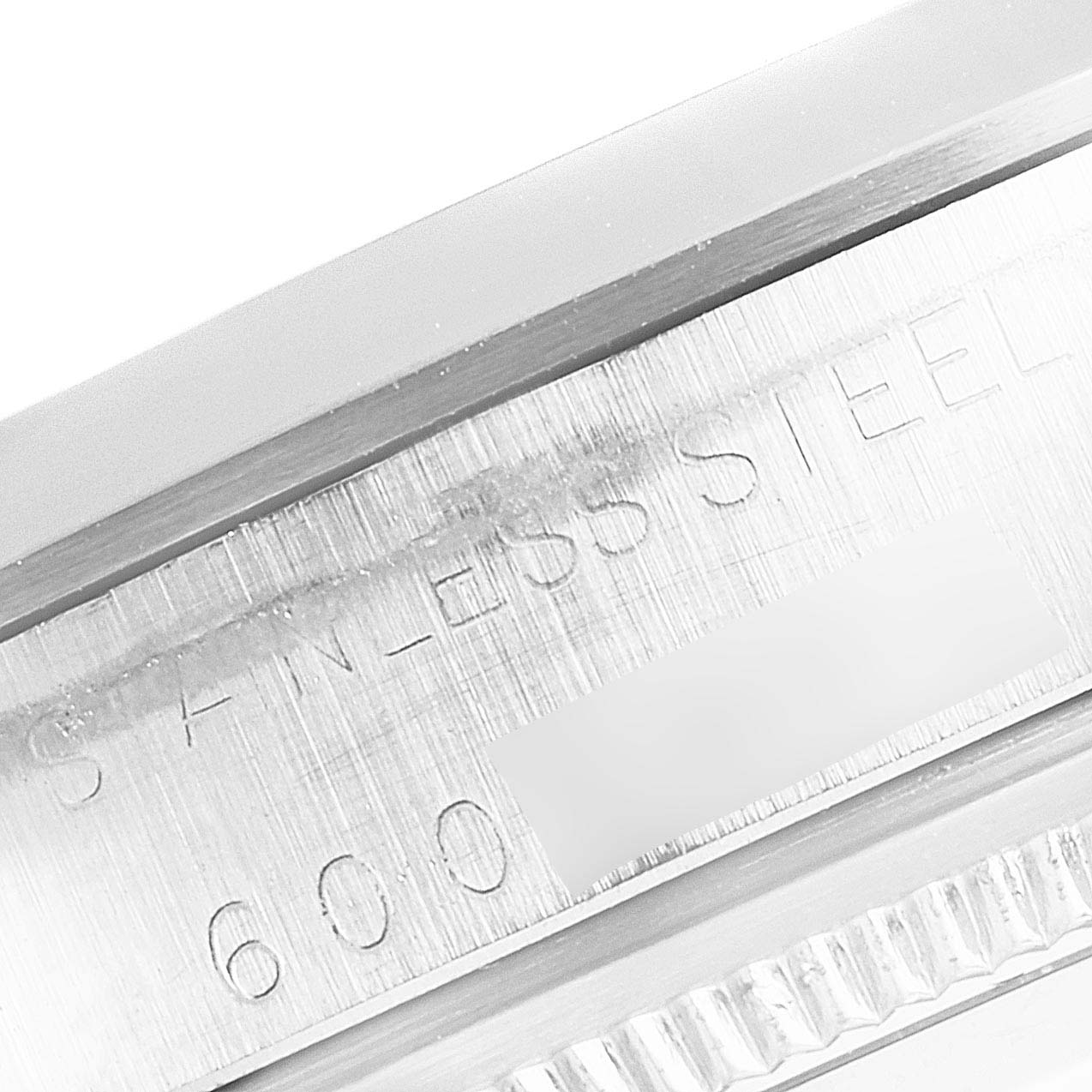 This image shows a close-up of the side engraving and stainless steel case of a Rolex Vintage Collection 1500 Men's Stainless Steel Silver Dial 1500 Men's Stainless Steel Silver Dial watch.