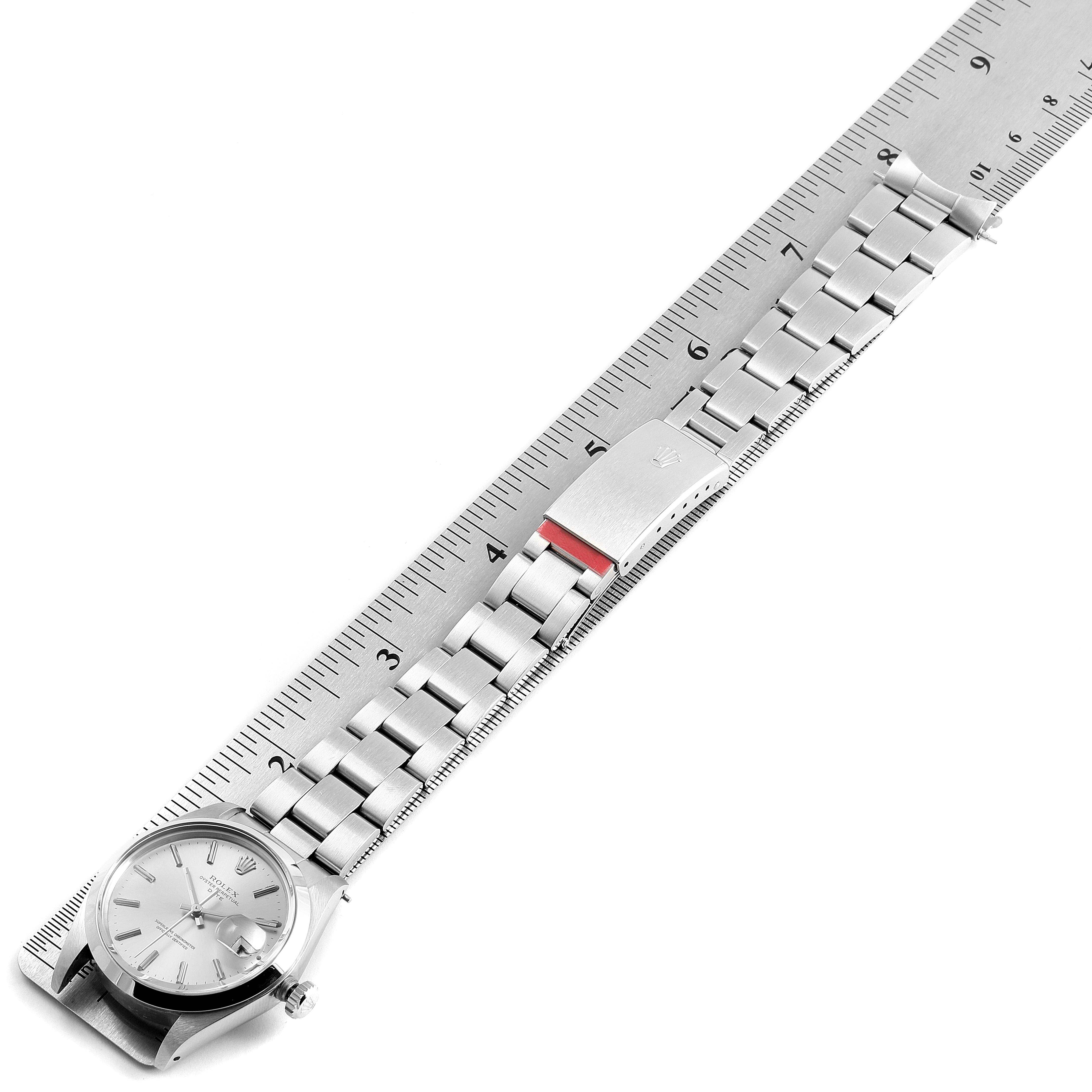 The image shows the Rolex Vintage Collection 1500 Men's Stainless Steel Silver Dial 1500 Men's Stainless Steel Silver Dial watch in a flat position, highlighting the face, bracelet, and clasp alongside a ruler.