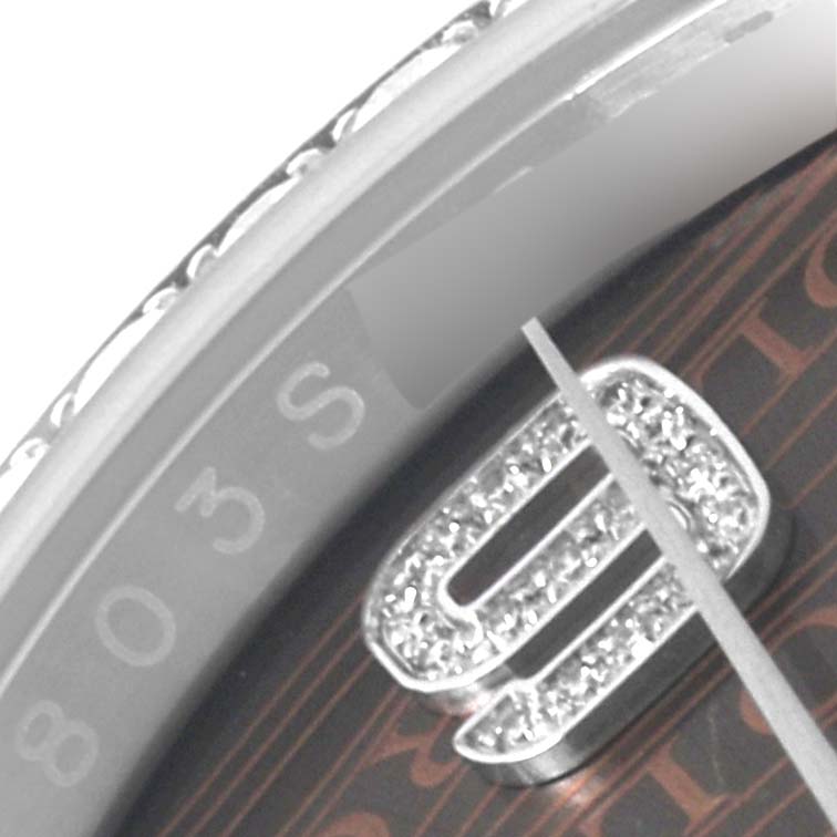 This close-up image of the Rolex Datejust 116244 Men's Stainless Steel Brown Dial 116244 Men's Stainless Steel Brown Dial watch shows a partial view of the bezel and dial with the 9 o'clock marker.