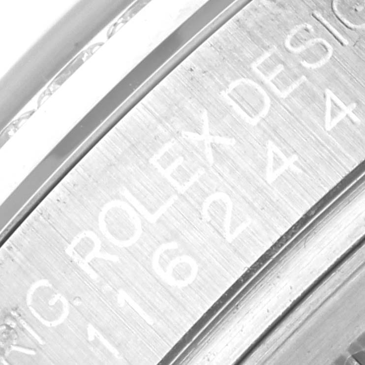 This image shows a close-up of the inner bezel of a Rolex Datejust 116244 Men's Stainless Steel Brown Dial 116244 Men's Stainless Steel Brown Dial watch.