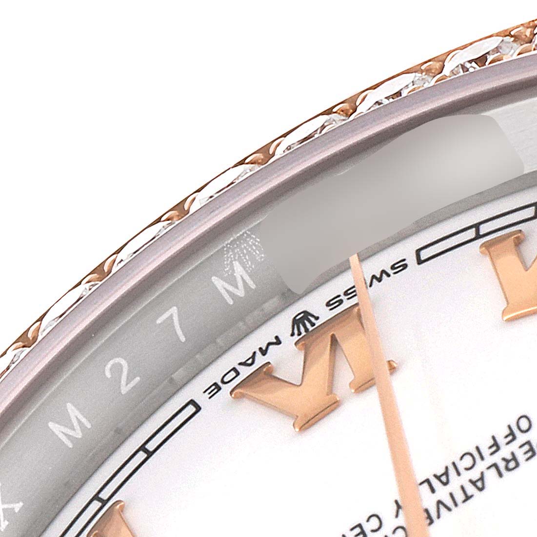 This close-up of a Rolex Datejust 126281 Men's Steel and Gold (two tone) White Dial 126281 Men's Steel and Gold (two tone) White Dial watch shows the bezel, part of the dial, and the minute hand.