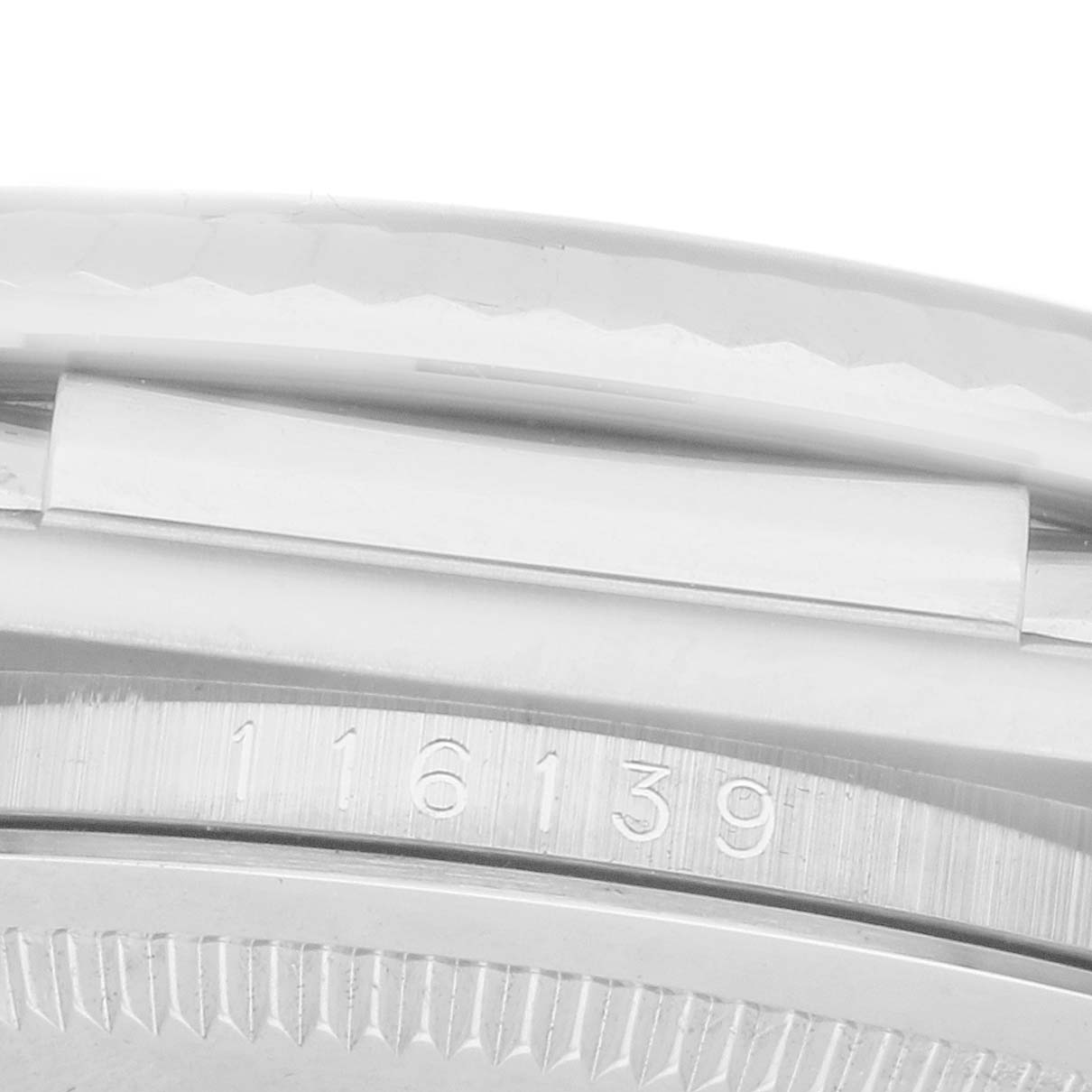 The image shows a close-up of the Rolex Datejust 116139 Men
s White Gold Black Dial model
s case edge, focusing on the serial number and part of the bezel.