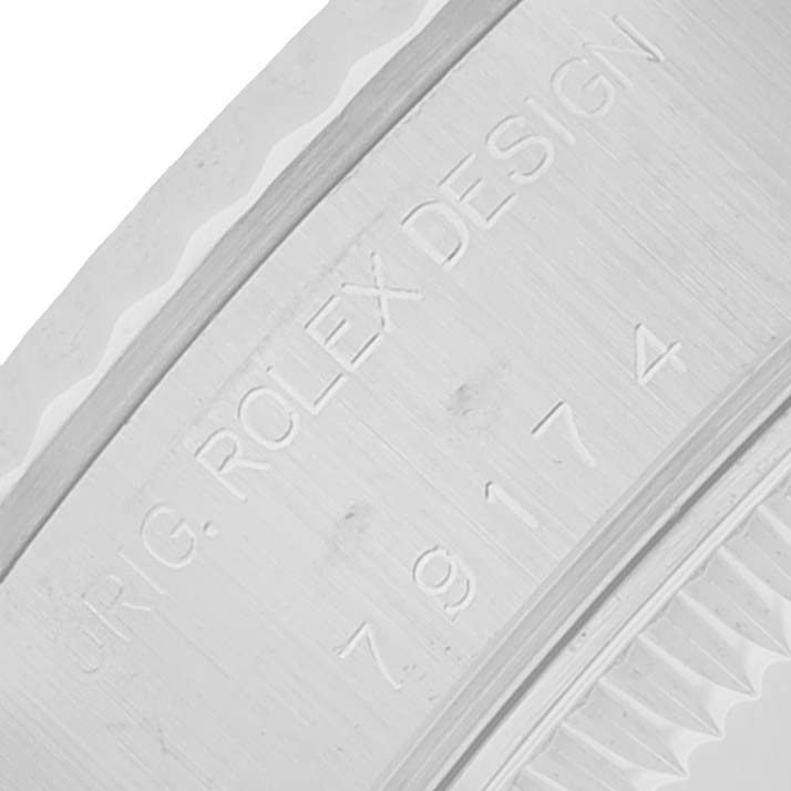 The image shows a close-up of the inner case engraving on a Rolex Datejust 79174 Women
s Stainless Steel Black Dial, featuring the model number and "Rolex Design."