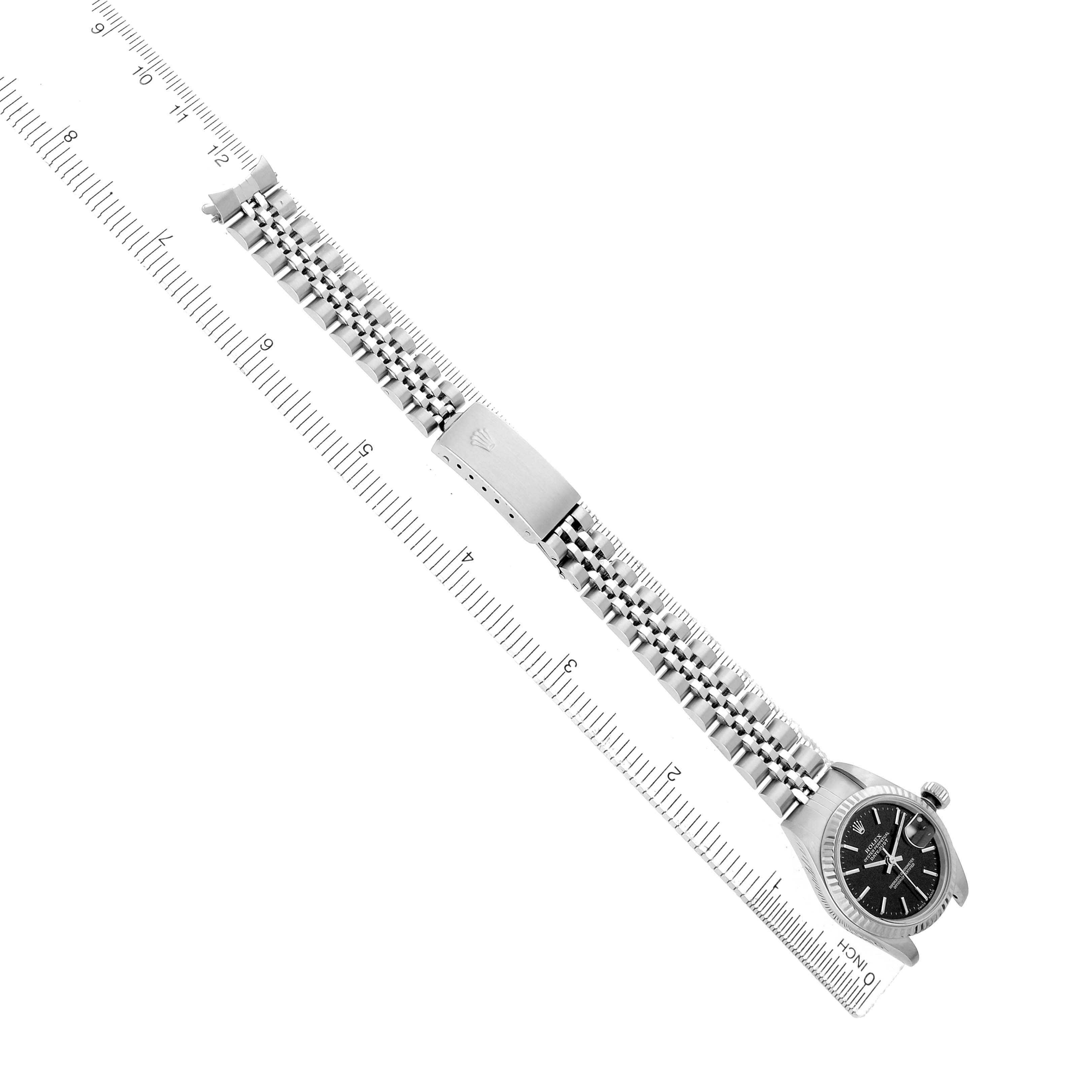 The Rolex Datejust 79174 Women
s Stainless Steel Black Dial watch is shown from a top-down angle, featuring the full bracelet, clasp, and part of the dial.