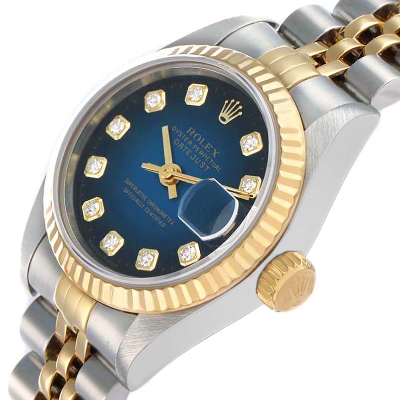 The Rolex Datejust 69173 Men
s Steel and Gold (two tone) Blue Dial watch is angled to show the blue dial, gold fluted bezel, and two-tone bracelet, with a focus on the crown and date magnifier.