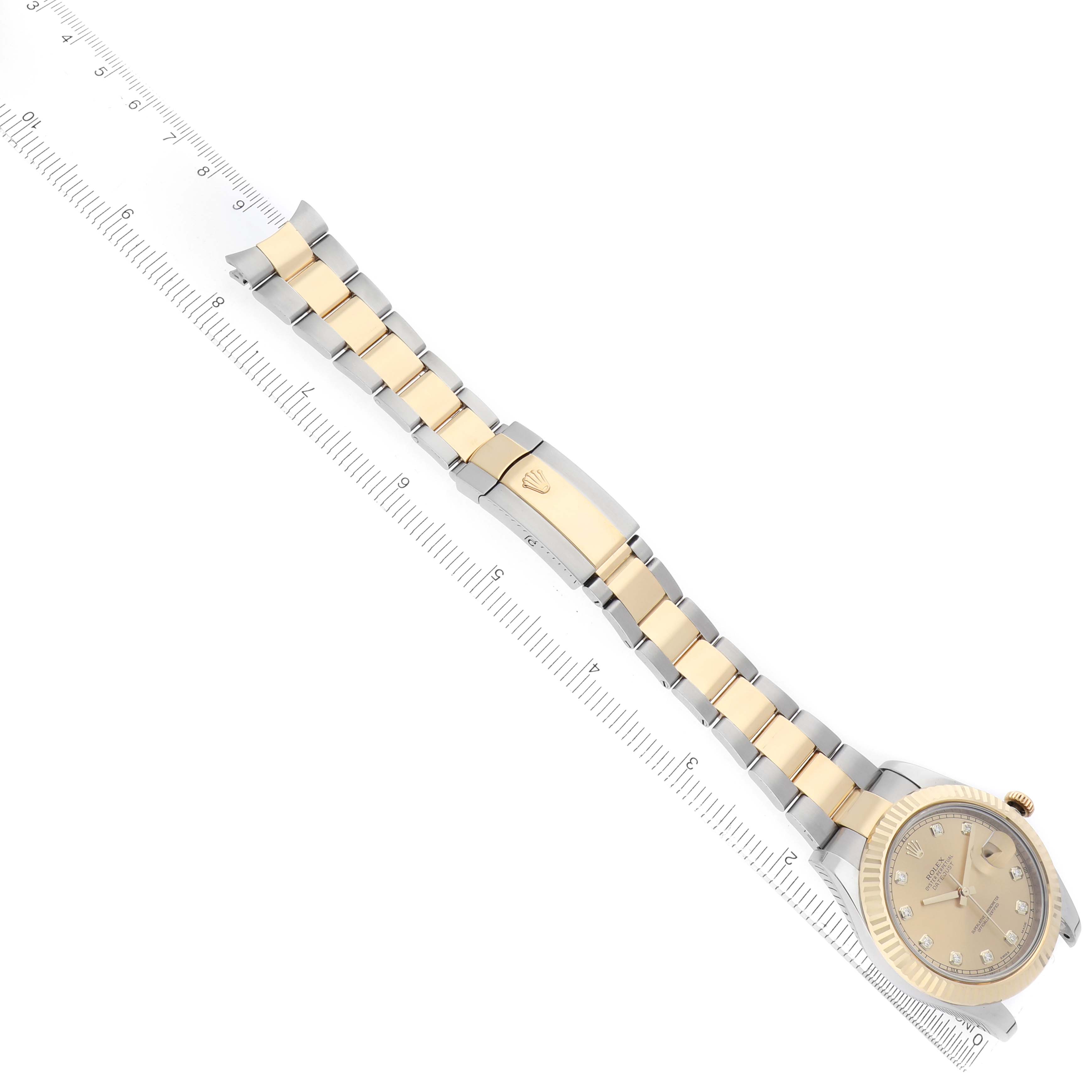 The Rolex Datejust 41 116333 Men
s Steel and Gold (two tone) Champagne Dial is shown from a top angle displaying the full bracelet and clasp alongside a ruler for sizing.