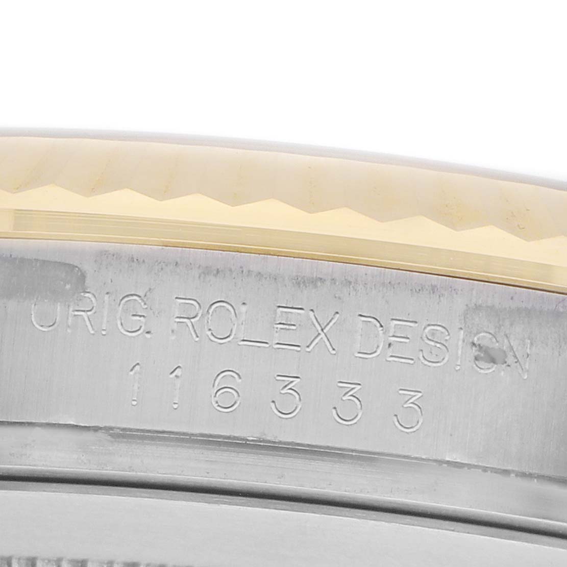 The image shows a close-up of the edge and engraving on the bezel of the Rolex Datejust 41 116333 Men
s Steel and Gold (two tone) Champagne Dial.