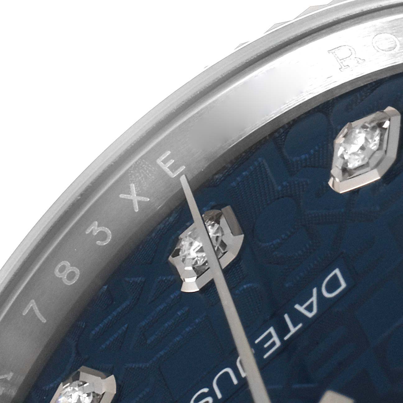 This close-up image shows part of the dial, the edge of the case, and the bezel of a Rolex Datejust 126234 Men's Stainless Steel Blue Dial 126234 Men's Stainless Steel Blue Dial watch.