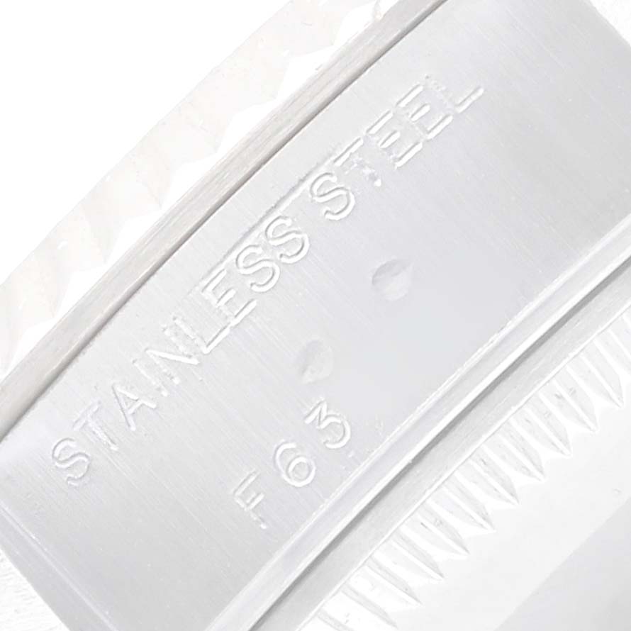 The image shows a close-up of the inner side of the bezel of a Rolex Datejust 79174 Men
s Stainless Steel Pink Dial, focusing on the "Stainless Steel" engraving.