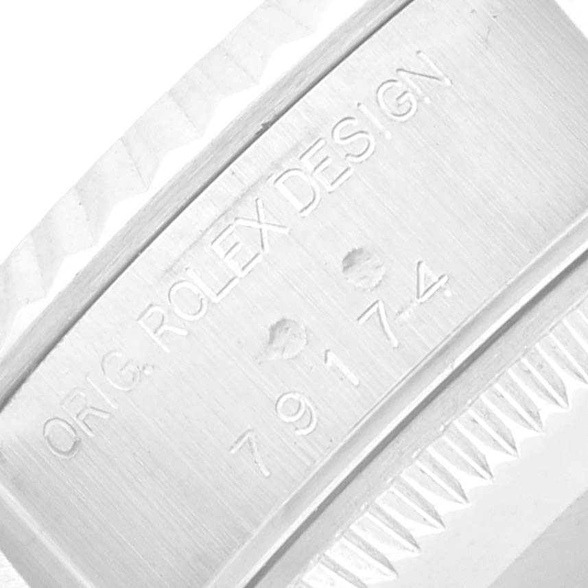 The close-up image shows the engraved bezel of the Rolex Datejust 79174 Men
s Stainless Steel Pink Dial watch, highlighting its design details.