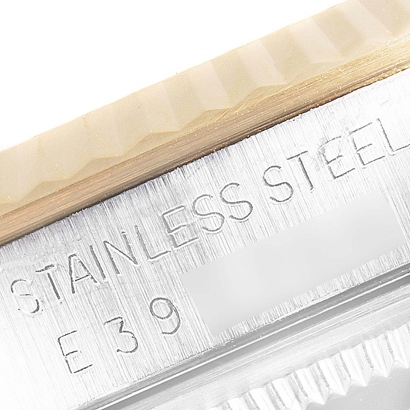 This image shows a close-up of the stainless steel casing and serial number engraving on a Rolex Datejust 16233 Men's Steel and Gold (two tone) Blue Dial 16233 Men's Steel and Gold (two tone) Blue Dial watch.