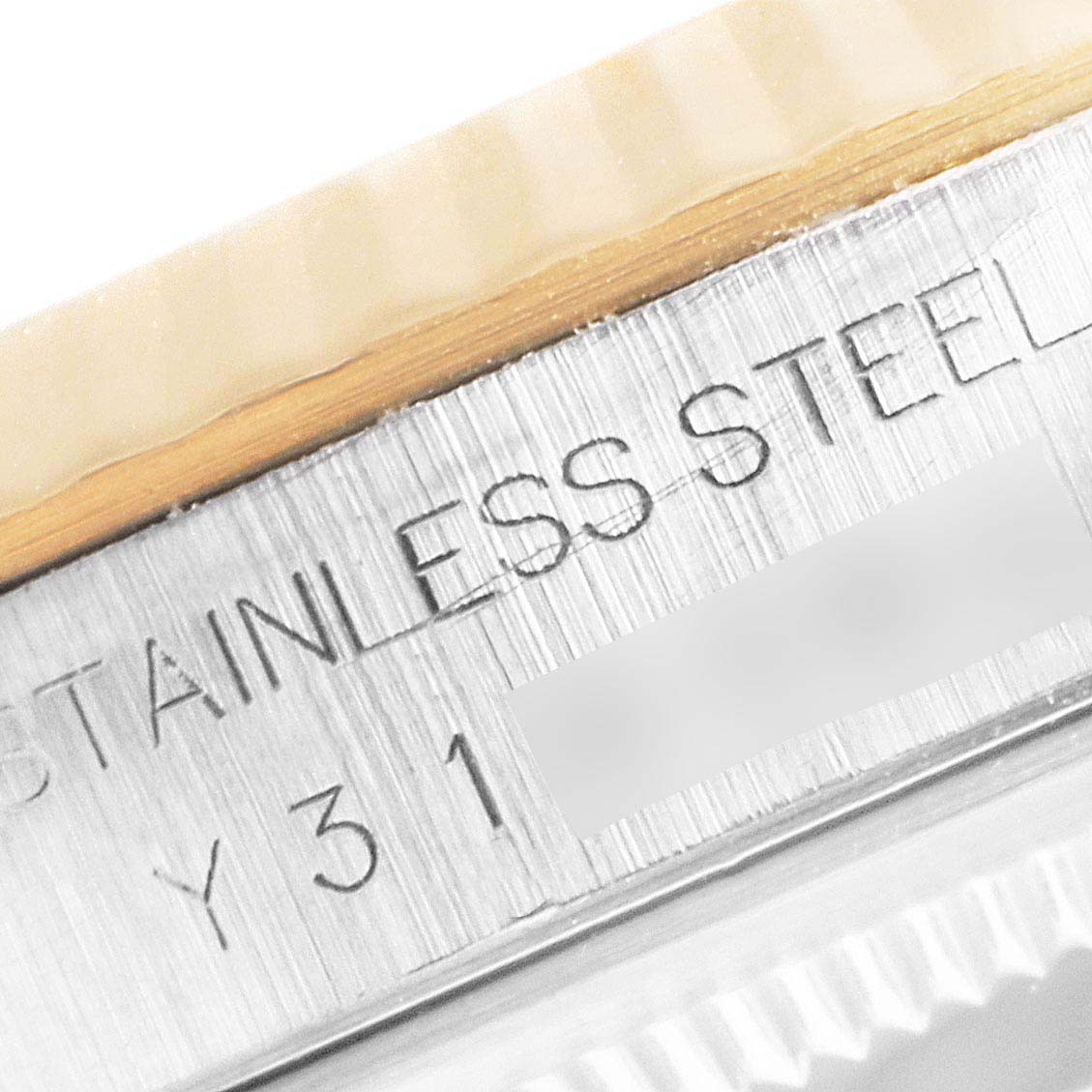 This image shows a close-up of the Rolex Datejust 16233 Men's Steel and Gold (two tone) Blue Dial 16233 Men's Steel and Gold (two tone) Blue Dial's stainless steel case with part of the bezel and reference engraving visible.