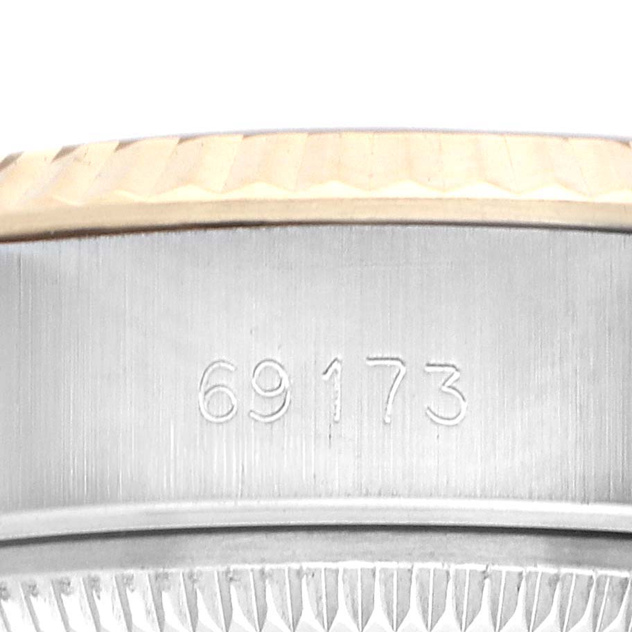 The image shows a close-up of the side of a Rolex Datejust 69173 Women
s Steel and Gold (two tone) Champagne Dial watch, highlighting the model number and part of the bezel.