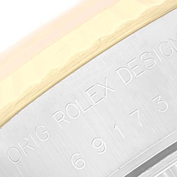 This image shows a close-up angle of a Rolex Datejust 69173 Women's Steel and Gold (two tone) White Dial 69173 Women's Steel and Gold (two tone) White Dial watch case, highlighting the engraved “Orig Rolex Design” lettering.