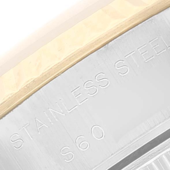 This close-up image shows the engraved "STAINLESS STEEL" text on the bezel or inner ring of a Rolex Datejust 69173 Women's Steel and Gold (two tone) White Dial 69173 Women's Steel and Gold (two tone) White Dial watch.