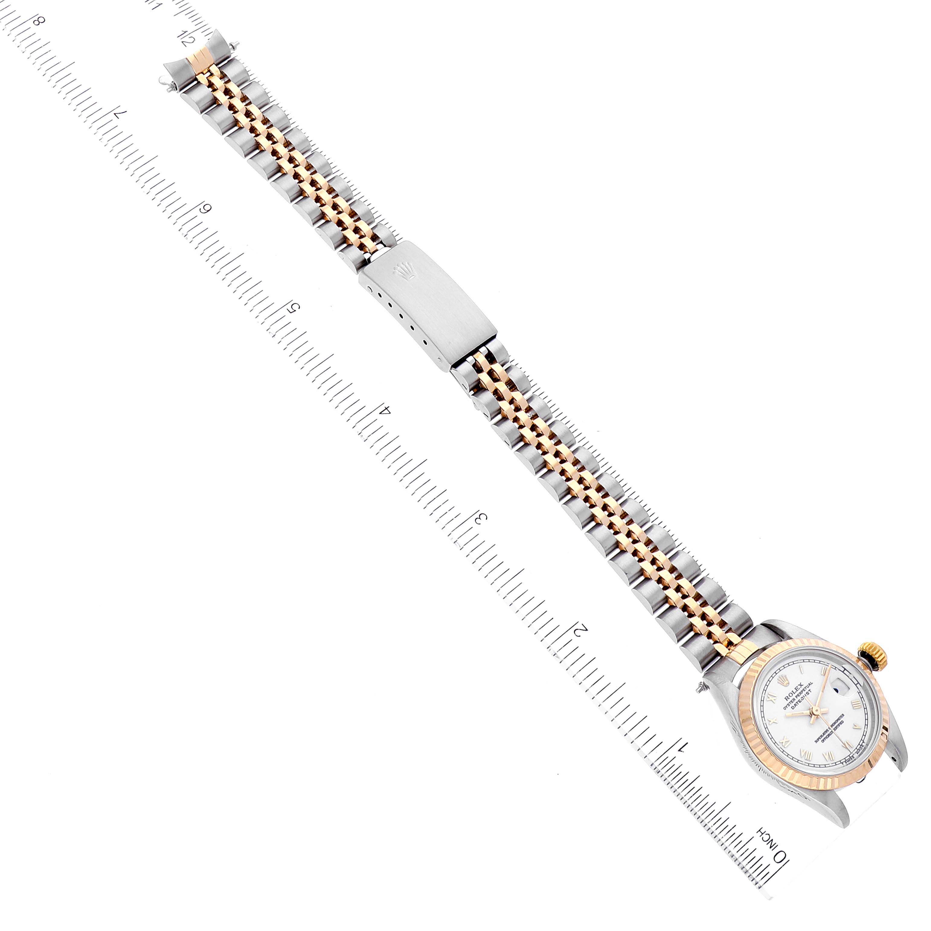 The Rolex Datejust 69173 Women's Steel and Gold (two tone) White Dial 69173 Women's Steel and Gold (two tone) White Dial watch is shown from a top-down angle, displaying the bracelet, clasp, and partial face with ruler measurements.