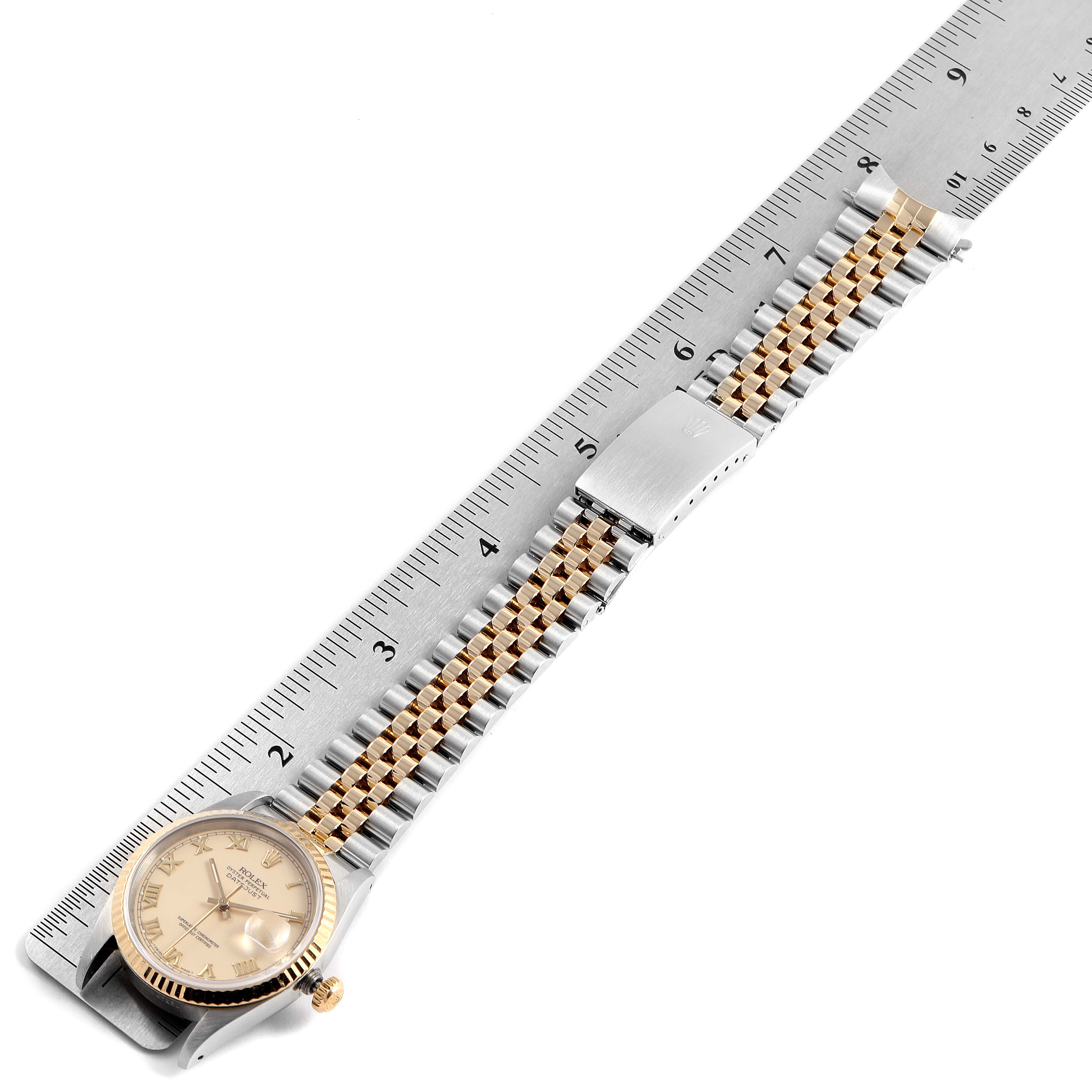 The image shows a Rolex Datejust 16233 Men's Steel and Gold (two tone) Beige Dial 16233 Men's Steel and Gold (two tone) Beige Dial watch with a two-tone bracelet laid next to a ruler, viewed from an angled top-down perspective.
