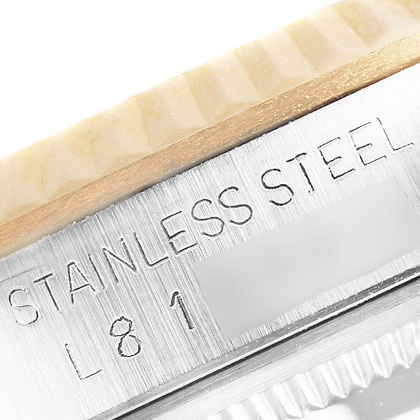 This close-up image shows the stainless steel engraving on the side of a Rolex Datejust 16233 Men's Steel and Gold (two tone) Beige Dial 16233 Men's Steel and Gold (two tone) Beige Dial watch case.