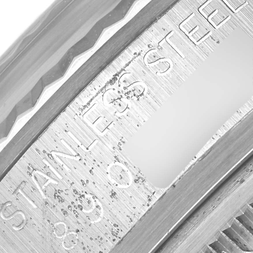 This image shows a close-up angle of the bezel and the inner rim of a vintage Rolex Vintage Collection 16014 Men's Stainless Steel Black Dial 16014 Men's Stainless Steel Black Dial watch, highlighting the "STAINLESS STEEL" engraving.