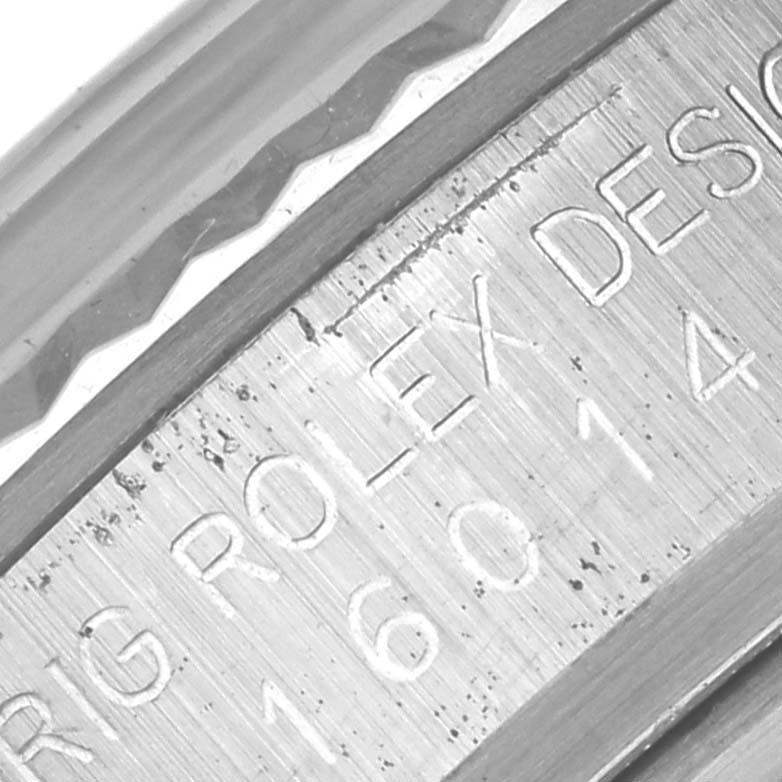 This image shows an angled close-up of the engraved bezel and inner rim of the Rolex Vintage Collection 16014 Men's Stainless Steel Black Dial 16014 Men's Stainless Steel Black Dial watch.