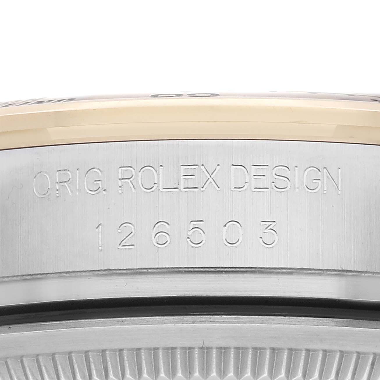 The image shows the side view of the Rolex Daytona 126503 Men
s Steel and Gold (two tone) Champagne Dial model with the engraved "ORIG. ROLEX DESIGN" and model number "126503."